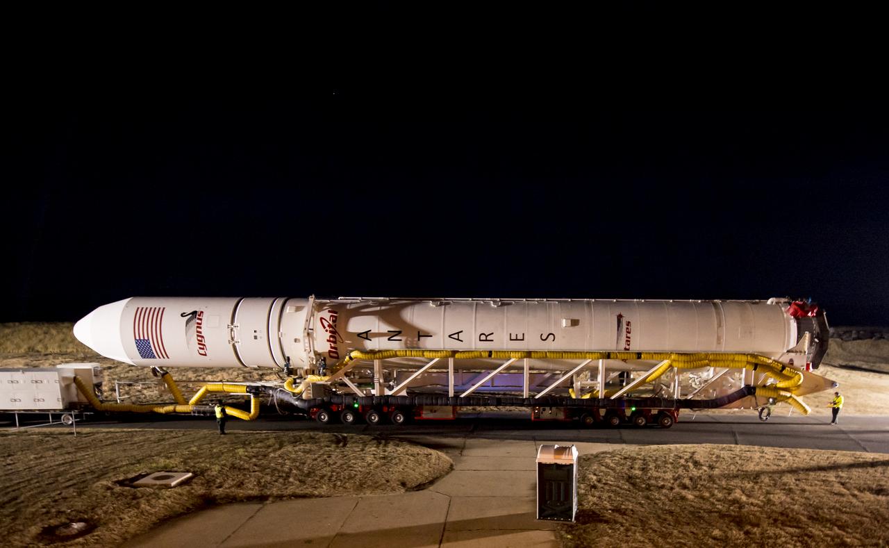 An Orbital Science Corporation Antares rocket is seen as it is rolled out to launch Pad-0A at NASA's Wallops Flight Facility Tuesday, December 17, 2013 in advance of a Thursday launch, Wallops Island, VA. The Antares will launch a Cygnus spacecraft on a cargo resupply mission to the International Space Station. The Orbital-1 mission is Orbital Sciences' first contracted cargo delivery flight to the space station for NASA. Among the cargo aboard Cygnus set to launch to the space station are science experiments, crew provisions, spare parts and other hardware. Launch is scheduled for 9:19 p.m. EST on Thursday, Dec. 19. Weather permitting, it may be widely visible along the east coast of the United States. Photo Credit: (NASA/Bill Ingalls)
