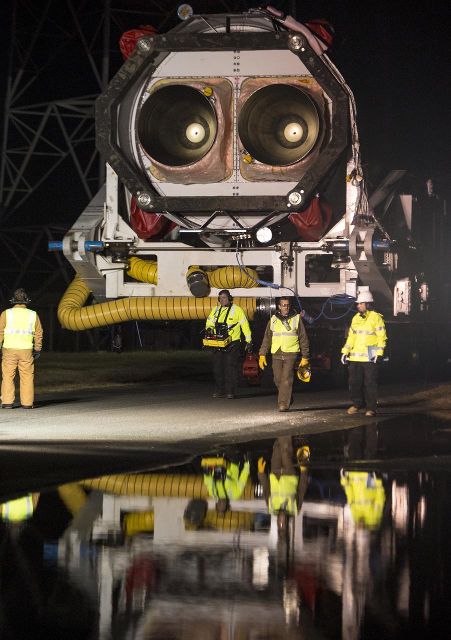 An Orbital Science Corporation Antares rocket is seen as it is rolled out to launch Pad-0A at NASA's Wallops Flight Facility Tuesday, December 17, 2013 in advance of a Thursday launch, Wallops Island, VA. The Antares will launch a Cygnus spacecraft on a cargo resupply mission to the International Space Station. The Orbital-1 mission is Orbital Sciences' first contracted cargo delivery flight to the space station for NASA. Among the cargo aboard Cygnus set to launch to the space station are science experiments, crew provisions, spare parts and other hardware. Launch is scheduled for 9:19 p.m. EST on Thursday, Dec. 19. Weather permitting, it may be widely visible along the east coast of the United States. Photo Credit: (NASA/Bill Ingalls)