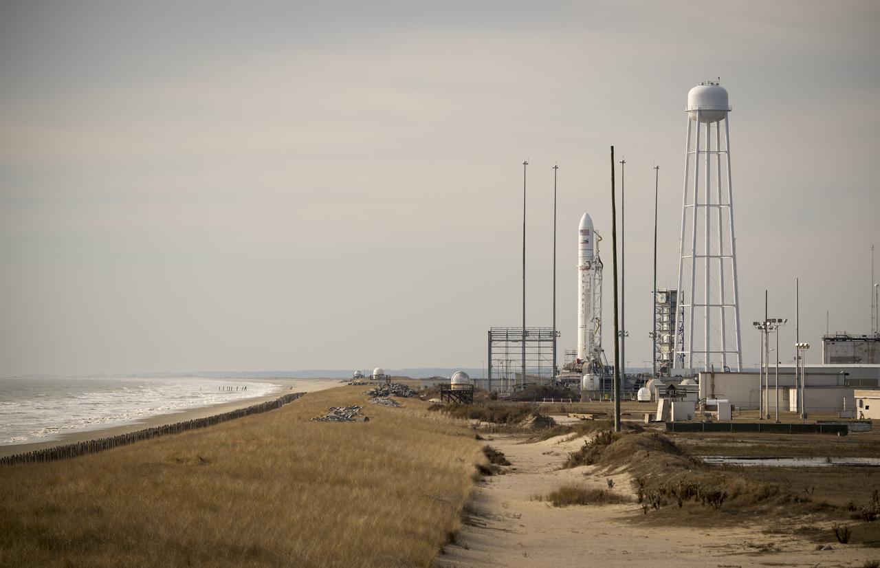 The Orbital Science Corporation Antares rocket is seen shortly after it was raised into position at launch Pad-0A, Tuesday, December 17, 2013, at NASA's Wallops Flight Facility, Wallops Island, VA. The Antares will launch a Cygnus spacecraft on a cargo resupply mission to the International Space Station. The Orbital-1 mission is Orbital Sciences' first contracted cargo delivery flight to the space station for NASA. Among the cargo aboard Cygnus set to launch to the space station are science experiments, crew provisions, spare parts and other hardware. Launch is scheduled for 9:19 p.m. EST on Thursday, Dec. 19. Weather permitting, it may be widely visible along the east coast of the United States. Photo Credit: (NASA/Bill Ingalls)