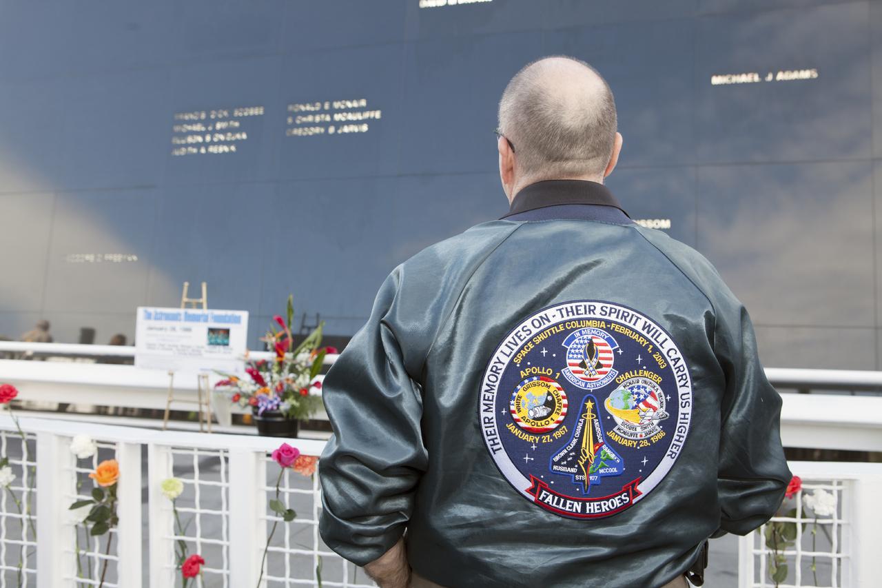 CAPE CANAVERAL, Fla. – The emblem on the jacket of a guest at NASA's Kennedy Space Center Visitor Complex commemorates NASA's 'fallen heroes' whose names are etched on the Astronauts Memorial Foundation's Space Mirror Memorial, following a ceremony on the 28th anniversary of the space shuttle Challenger accident.  The day of the accident in 1986 dawned bitterly cold. Temperatures hovered just a few degrees above freezing as Challenger and its seven astronauts lifted off on the STS-51L mission. The flight ended just 73 seconds later when an O-ring in the right solid rocket booster failed, causing a fireball that led to the loss of the vehicle and crew: Commander Francis Scobee, Pilot Michael Smith, Mission Specialists Judith Resnik, Ellison Onizuka and Ronald McNair, and Payload Specialists Gregory Jarvis and Sharon Christa McAuliffe, a teacher. To learn more about the Space Shuttle Program, visit http:__www.nasa.gov_mission_pages_shuttle_main_index.html. To read the astronauts' NASA biographies, visit http:__www.jsc.nasa.gov_Bios_astrobio_former.html.  For information about the AMF, visit http:__www.astronautsmemorial.org_home.html. Photo credit: NASA_Dimitri Gerondidakis