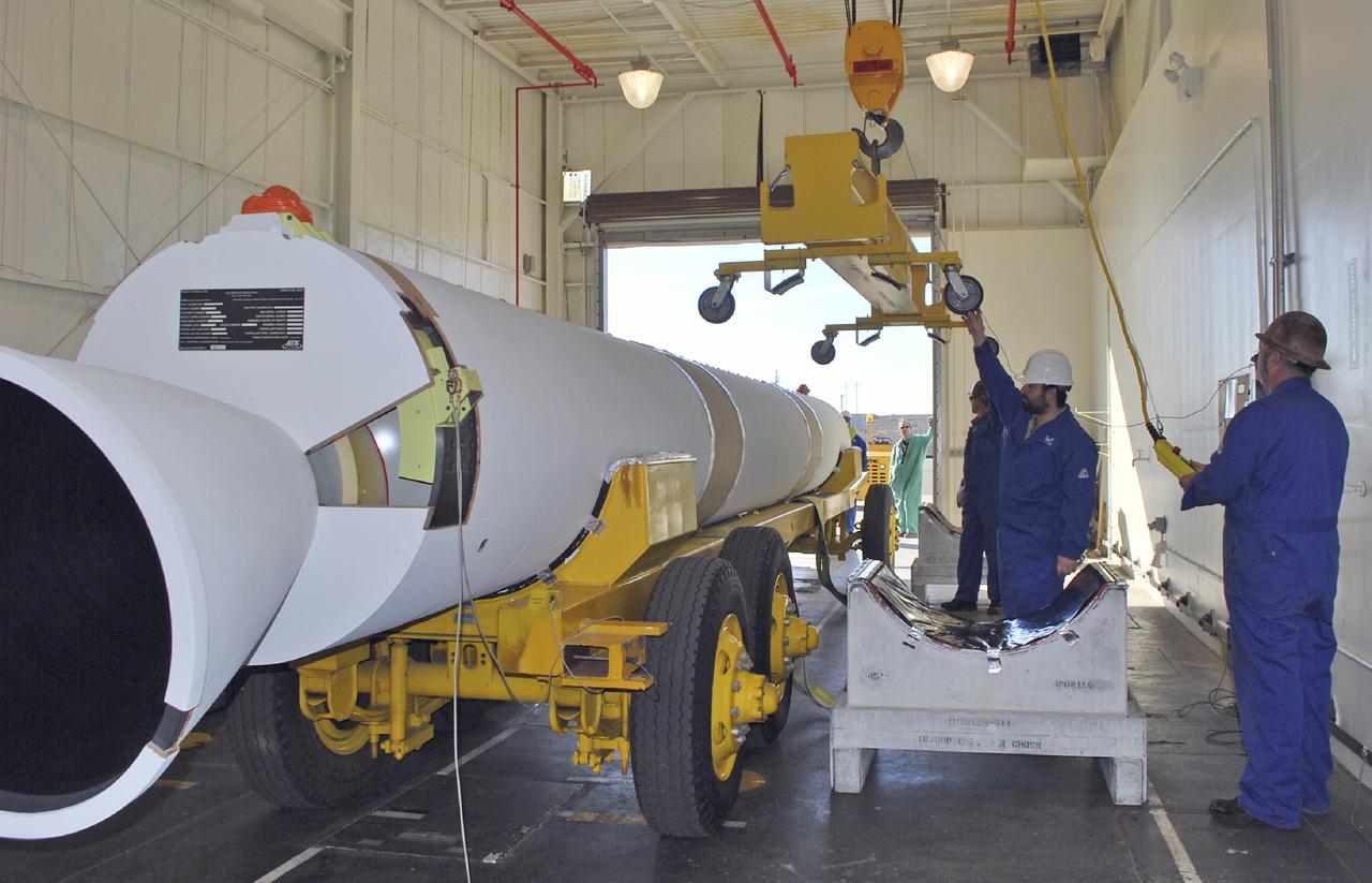 VANDENBERG AIR FORCE BASE, Calif. – Workers at Vandenberg Air Force Base in California prepare to lift a solid rocket motor, or SRM, for NASA's Orbiting Carbon Observatory-2, the OCO-2 mission, from a transporter onto a storage chock where it will be kept until needed. The SRMs will be attached to a United Launch Alliance Delta II rocket slated to launch the OCO-2 spacecraft from Space Launch Complex 2 in July. OCO-2 will collect precise global measurements of carbon dioxide in the Earth's atmosphere and provide scientists with a better idea of the chemical compound's impacts on climate change. Scientists will analyze this data to improve our understanding of the natural processes and human activities that regulate the abundance and distribution of this important atmospheric gas. Photo credit: NASA_Randy Beaudoin