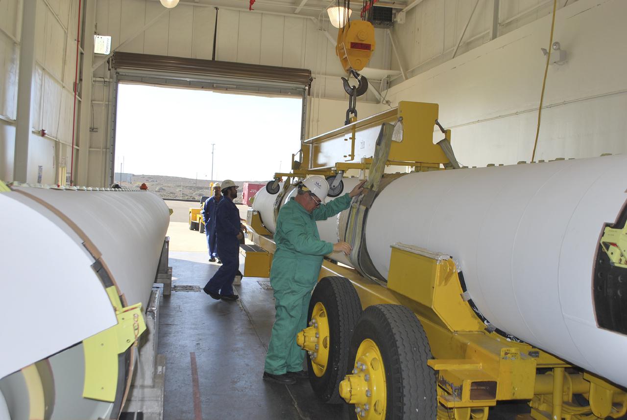 VANDENBERG AIR FORCE BASE, Calif. – Workers at Vandenberg Air Force Base in California prepare to hoist a solid rocket motor, or SRM, for NASA's Orbiting Carbon Observatory-2, the OCO-2 mission, from a transporter onto a storage chock where it will be kept until needed. The SRMs will be attached to a United Launch Alliance Delta II rocket slated to launch the OCO-2 spacecraft from Space Launch Complex 2 in July. OCO-2 will collect precise global measurements of carbon dioxide in the Earth's atmosphere and provide scientists with a better idea of the chemical compound's impacts on climate change. Scientists will analyze this data to improve our understanding of the natural processes and human activities that regulate the abundance and distribution of this important atmospheric gas. Photo credit: NASA_Randy Beaudoin