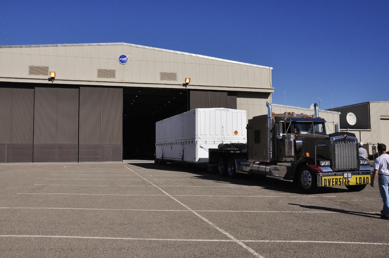 VANDENBERG AIR FORCE BASE, Calif. – The fairing for NASA's Orbiting Carbon Observatory-2, or OCO-2, mission is delivered to the high bay of NASA Building 836 at Vandenberg Air Force Base in California.   The fairing will protect OCO-2 during launch aboard a United Launch Alliance Delta II rocket from Space Launch Complex 2 in July. OCO-2 will collect precise global measurements of carbon dioxide in the Earth's atmosphere and provide scientists with a better idea of the chemical compound's impacts on climate change. Scientists will analyze this data to improve our understanding of the natural processes and human activities that regulate the abundance and distribution of this important atmospheric gas. Photo credit: NASA_Randy Beaudoin
