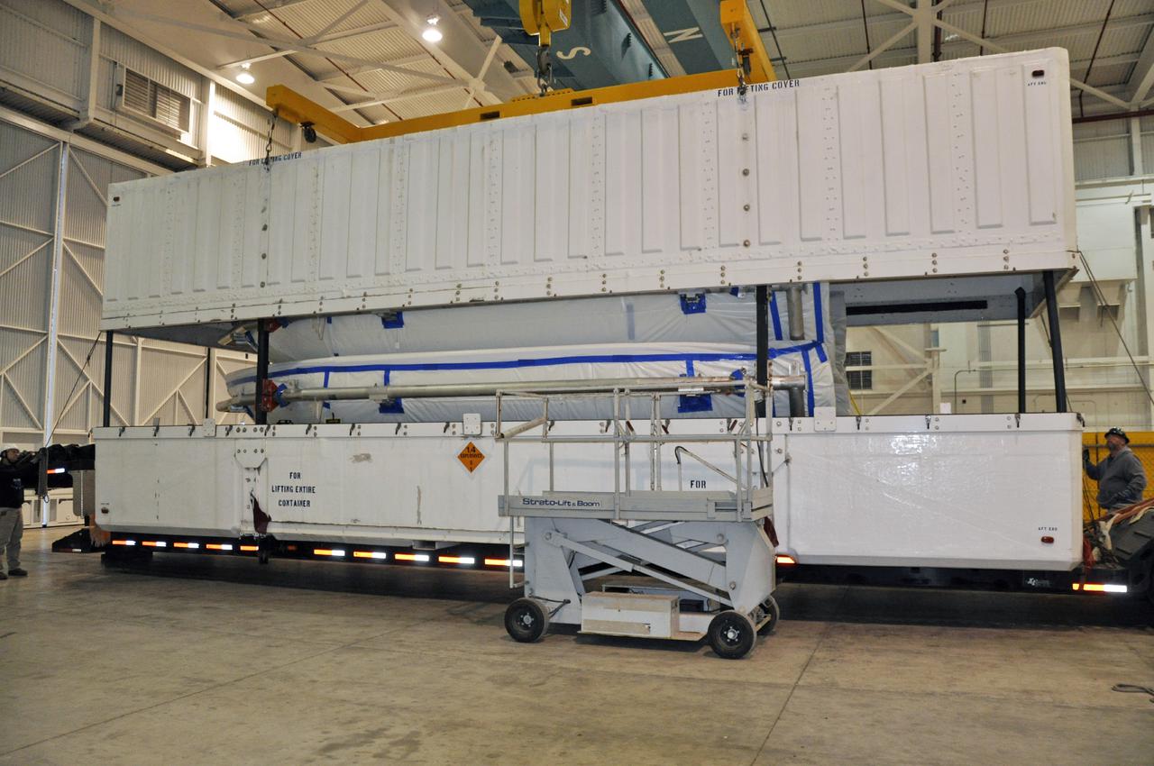 VANDENBERG AIR FORCE BASE, Calif. – The shipping container is removed from around the fairing for NASA's Orbiting Carbon Observatory-2 mission, or OCO-2, in the NASA Building 836 high bay at Vandenberg Air Force Base in California.     The fairing will protect OCO-2 during launch aboard a United Launch Alliance Delta II rocket from Space Launch Complex 2 in July. OCO-2 will collect precise global measurements of carbon dioxide in the Earth's atmosphere and provide scientists with a better idea of the chemical compound's impacts on climate change. Scientists will analyze this data to improve our understanding of the natural processes and human activities that regulate the abundance and distribution of this important atmospheric gas. To learn more about OCO-2, visit http:__oco.jpl.nasa.gov.  Photo credit: NASA_Randy Beaudoin