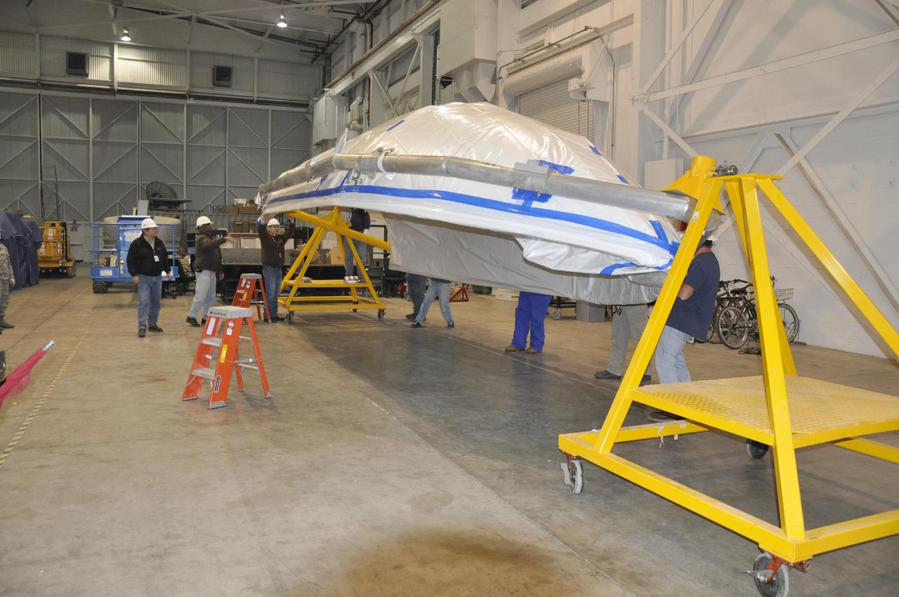 VANDENBERG AIR FORCE BASE, Calif. – A section of the fairing for NASA's Orbiting Carbon Observatory-2 mission, or OCO-2, is rotated into position for attachment on a turnover fixture in the NASA Building 836 high bay at Vandenberg Air Force Base in California.    The fairing will protect OCO-2 during launch aboard a United Launch Alliance Delta II rocket from Space Launch Complex 2 in July. OCO-2 will collect precise global measurements of carbon dioxide in the Earth's atmosphere and provide scientists with a better idea of the chemical compound's impacts on climate change. Scientists will analyze this data to improve our understanding of the natural processes and human activities that regulate the abundance and distribution of this important atmospheric gas. To learn more about OCO-2, visit http:__oco.jpl.nasa.gov.  Photo credit: NASA_Randy Beaudoin