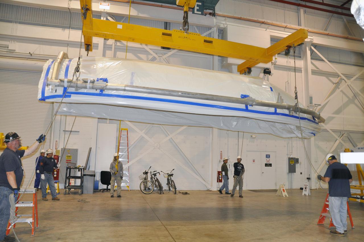 VANDENBERG AIR FORCE BASE, Calif. – In the NASA Building 836 high bay at Vandenberg Air Force Base in California, workers steady a section of the fairing for NASA's Orbiting Carbon Observatory-2 mission, or OCO-2, attached to a turnover fixture.     The fairing will protect OCO-2 during launch aboard a United Launch Alliance Delta II rocket from Space Launch Complex 2 in July. OCO-2 will collect precise global measurements of carbon dioxide in the Earth's atmosphere and provide scientists with a better idea of the chemical compound's impacts on climate change. Scientists will analyze this data to improve our understanding of the natural processes and human activities that regulate the abundance and distribution of this important atmospheric gas. To learn more about OCO-2, visit http:__oco.jpl.nasa.gov.  Photo credit: NASA_Randy Beaudoin