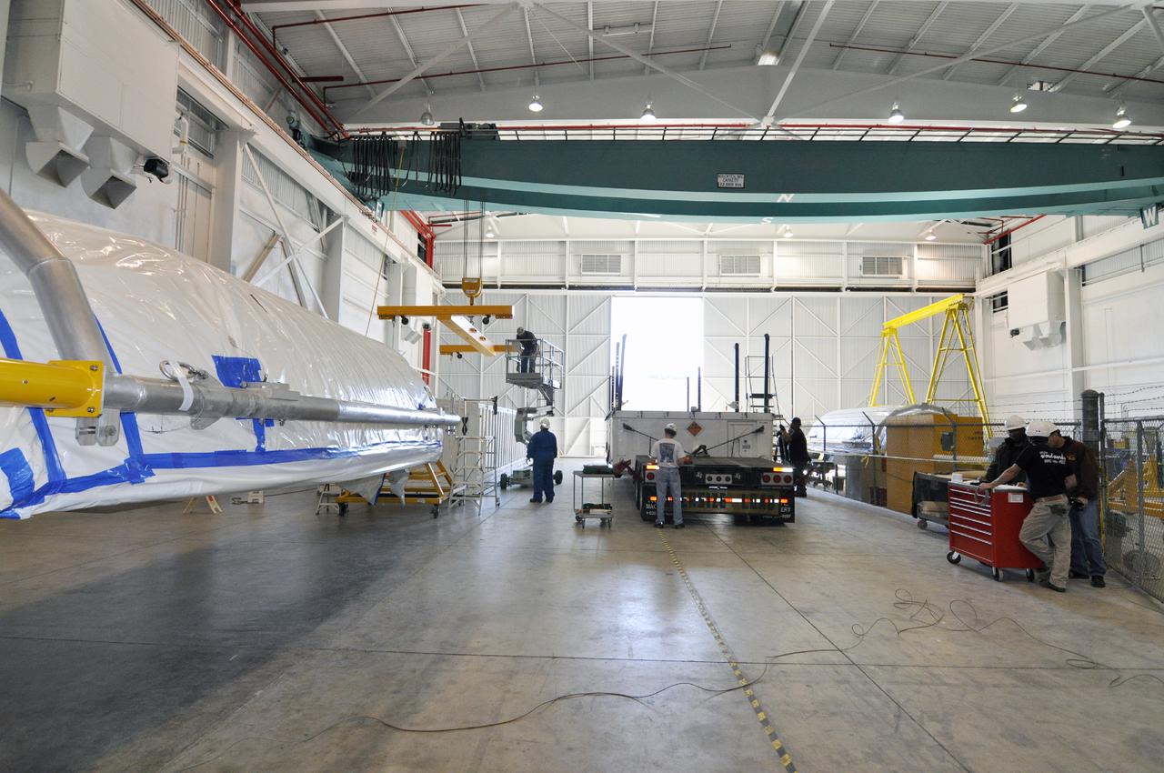 VANDENBERG AIR FORCE BASE, Calif. – In the NASA Building 836 high bay at Vandenberg Air Force Base in California, both sections of the fairing for NASA's Orbiting Carbon Observatory-2 mission, or OCO-2, at left, have been removed from their shipping container, in the center aisle.      The fairing will protect OCO-2 during launch aboard a United Launch Alliance Delta II rocket from Space Launch Complex 2 in July. OCO-2 will collect precise global measurements of carbon dioxide in the Earth's atmosphere and provide scientists with a better idea of the chemical compound's impacts on climate change. Scientists will analyze this data to improve our understanding of the natural processes and human activities that regulate the abundance and distribution of this important atmospheric gas. To learn more about OCO-2, visit http:__oco.jpl.nasa.gov.  Photo credit: NASA_Randy Beaudoin