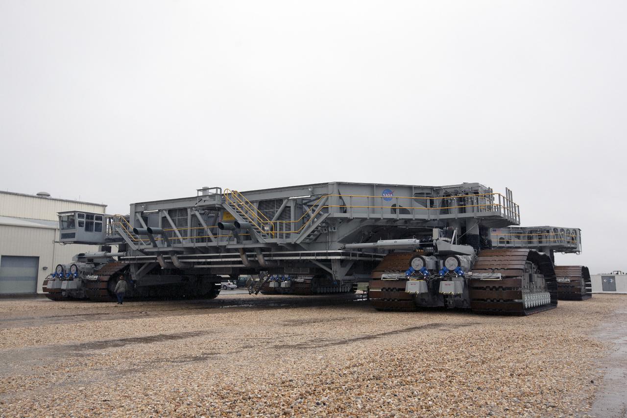 CAPE CANAVERAL, Fla. – Crawler-transporter 2, or CT-2, travels along the crawlerway toward the Vehicle Assembly Building at NASA’s Kennedy Space Center in Florida. The Ground Systems Development and Operations Program completed a roller bearing assembly test on CT-2 truck sections A and C. The left- and right-hand steering was tested in both directions. The temperature of the roller assemblies was monitored and recorded. Engineers and technicians performed visual inspections of the roller bearing pumps, valves and lines to ensure that the grease injectors worked properly and provided the required flow of grease to the new roller assemblies.  Work continues in high bay 2 to upgrade CT-2. The modifications are designed to ensure CT-2’s ability to transport launch vehicles currently in development, such as the agency’s Space Launch System, to the launch pad. The Ground Systems Development and Operations Program office at Kennedy is overseeing the upgrades. For more than 45 years the crawler-transporters were used to transport the mobile launcher platform and the Apollo-Saturn V rockets and, later, space shuttles to Launch Pads 39A and B. For more information, visit: http:__www.nasa.gov_exploration_systems_ground_crawler-transporter. Photo credit: NASA_Kim Shiflett