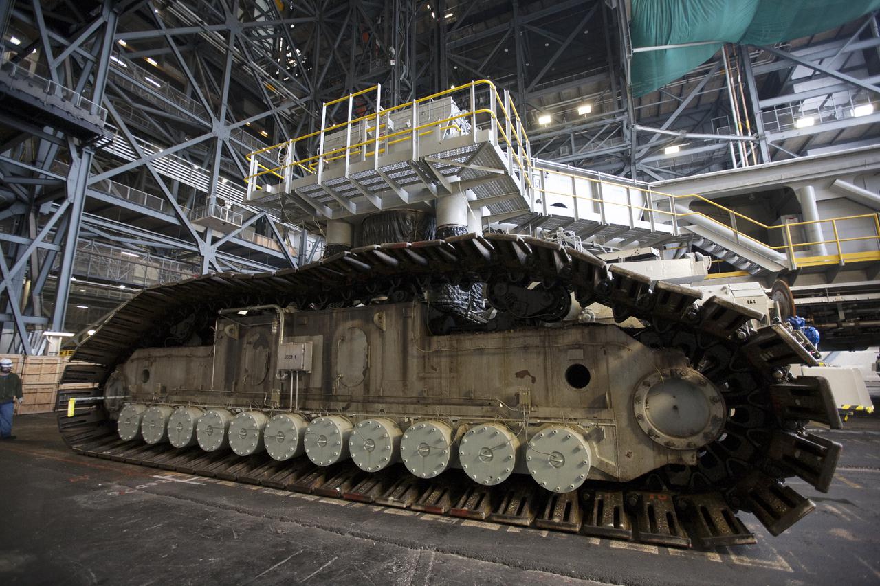 CAPE CANAVERAL, Fla. – Crawler-transporter 2, or CT-2, enters the Vehicle Assembly Building at NASA’s Kennedy Space Center in Florida. Visible are the new roller bearing assemblies that were installed on one side of the crawler. The Ground Systems Development and Operations Program completed a roller bearing assembly test on CT-2 truck sections A and C. The left- and right-hand steering was tested in both directions. The temperature of the roller assemblies was monitored and recorded as it traveled along the crawlerway. Engineers and technicians performed visual inspections of the roller bearing pumps, valves and lines to ensure that the grease injectors worked properly and provided the required flow of grease to the new roller assemblies.  Work continues in high bay 2 to upgrade CT-2. The modifications are designed to ensure CT-2’s ability to transport launch vehicles currently in development, such as the agency’s Space Launch System, to the launch pad. The Ground Systems Development and Operations Program office at Kennedy is overseeing the upgrades. For more than 45 years the crawler-transporters were used to transport the mobile launcher platform and the Apollo-Saturn V rockets and, later, space shuttles to Launch Pads 39A and B. For more information, visit: http:__www.nasa.gov_exploration_systems_ground_crawler-transporter. Photo credit: NASA_Kim Shiflett