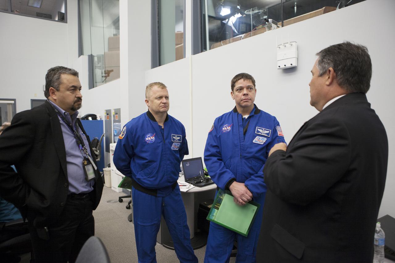 CAPE CANAVERAL, Fla. – During preparations for the launch of NASA's Tracking and Data Relay Satellite, or TDRS-L, spacecraft, astronauts Eric Boe, left, and Bob Behnken discuss the status of the countdown with NASA managers in Cape Canaveral Air Force Station's Atlas V Spaceflight Operations Center. The TDRS-L spacecraft is the second of three new satellites designed to ensure vital operational continuity for NASA by expanding the lifespan of the Tracking and Data Relay Satellite System TDRSS fleet, which consists of eight satellites in geosynchronous orbit. The spacecraft provide tracking, telemetry, command and high bandwidth data return services for numerous science and human exploration missions orbiting Earth. These include NASA's Hubble Space Telescope and the International Space Station. TDRS-L has a high-performance solar panel designed for more spacecraft power to meet the growing S-band communications requirements. TDRSS is one of NASA Space Communication and Navigation’s SCaN three networks providing space communications to NASA’s missions. For more information more about TDRS-L, visit: http:__www.nasa.gov_tdrs To learn more about SCaN, visit: www.nasa.gov_scan Photo credit: NASA_Kim Shiflett