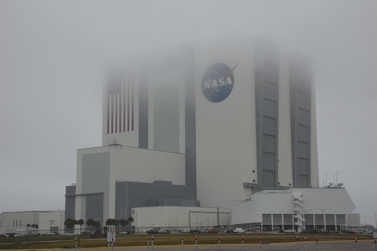 CAPE CANAVERAL, Fla. – Fog envelopes the top of the 525-foot-tall Vehicle Assembly Building at NASA's Kennedy Space Center in Florida.  The massive building, once used to process Apollo Saturn V rockets and space shuttles for launch, is undergoing a transformation to prepare it to support NASA's next-generation rocket, the Space Launch System, or SLS, as well as myriad commercial rockets under development. To learn more about the SLS, visit http:__www.nasa.gov_exploration_systems_sls_. For more on NASA's Commercial Crew Program, visit http:__www.nasa.gov_exploration_commercial_crew_. Photo credit: NASA_Ben Smegelsky