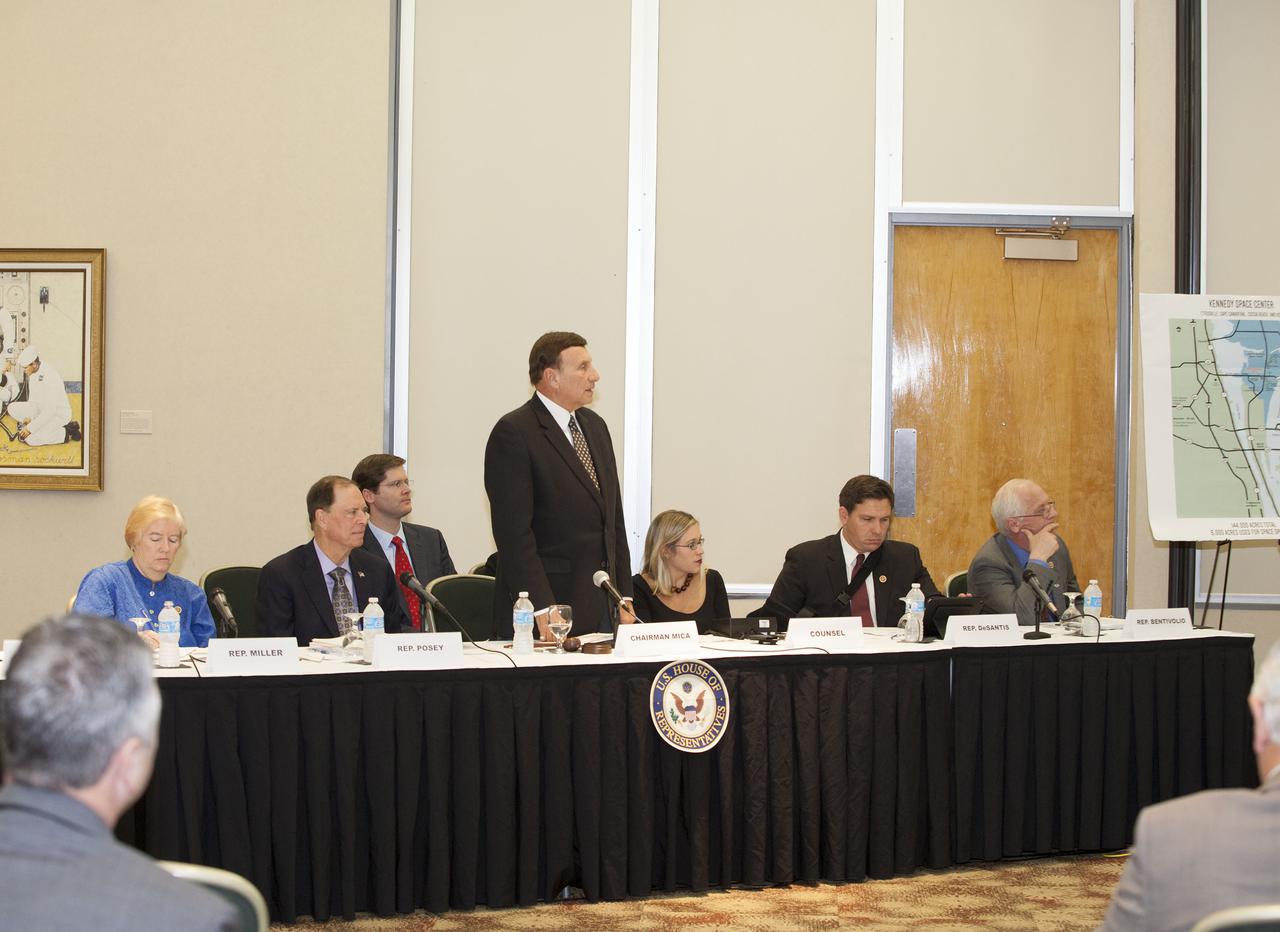CAPE CANAVERAL, Fla. – At the Kurt H. Debus Conference Facility at the Kennedy Space Center Visitor Complex, Rep. John Mica, R-Fla., standing, speaks to witnesses during a hearing of the U.S. House of Representatives' Subcommittee on Government Operations. From the left are Rep. Candace Miller, R-Mich., Rep. Bill Posey, R-Fla., Mica, the counsel for Rep. Mica, Rep. Ron Desantis, R-Fla., and Rep. Kerry Bentivollo, R-Mich.  The Congressional hearing took place to review plans for putting vacant buildings and excess property at the Kennedy Space Center to their best and most productive use. Photo credit: NASA_Daniel Casper