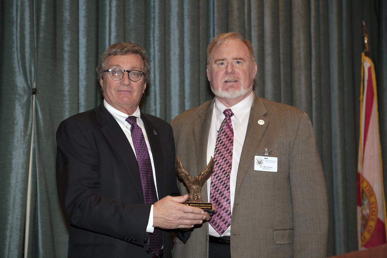 CAPE CANAVERAL, Fla. – Jim McCarthy right, president of the National Space Club-Florida Chapter, thanks Larry Price, deputy manager of the Orion Program for the Lockheed Martin Space Systems Company, for his presentation to members and guests at the Radisson Resort at the Port in Cape Canaveral, Fla. Price’s presentation included an overview of Orion processing, testing and preparations for Exploration Flight Test 1. Orion is the exploration spacecraft designed to carry astronauts to destinations not yet explored by humans. It will have emergency abort capability, sustain the crew during space travel and provide safe re-entry from deep space return velocities. The first unpiloted test flight of Orion is scheduled to launch in 2014 atop a Delta IV Heavy rocket and in 2017 on NASA’s Space Launch System rocket. For more information, visit www.nasa.gov_orion. Photo credit: Kim Shiflett
