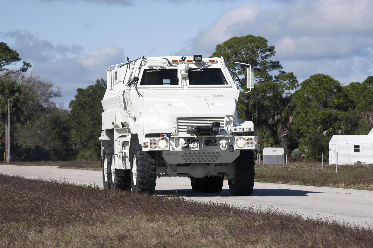 CAPE CANAVERAL, Fla. –One of four new emergency egress vehicles, called Mine-Resistant Ambush-Protection, or MRAP, vehicles is driven to the Maintenance and Operations Facility at NASA’s Kennedy Space Center in Florida. The MRAPs arrived from the U.S. Army Red River Depot in Texarkana, Texas in December 2013. The vehicles were processed in and then transported to the Rotation, Processing and Surge Facility near the Vehicle Assembly Building for temporary storage. The Ground Systems Development and Operations Program at Kennedy led the efforts to an emergency egress vehicle that future astronauts could quickly use to leave the Launch Complex 39 area in case of an emergency. During crewed launches of NASA’s Space Launch System and Orion spacecraft, the MRAP will be stationed by the slidewire termination area at the pad. In case of an emergency, the crew will ride a slidewire to the ground and immediately board the MRAP for safe egress from the pad. The new vehicles replace the M-113 vehicles that were used during the Space Shuttle Program. Photo credit: NASA_Kim Shiflett