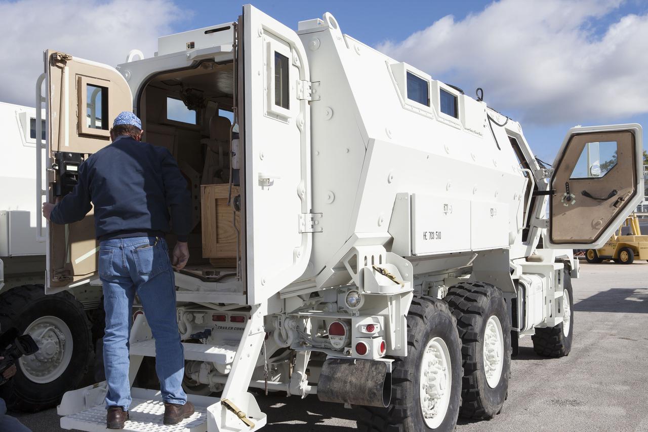 CAPE CANAVERAL, Fla. – A URS Federal Services worker enters one of the four new emergency egress vehicles, called Mine-Resistant Ambush-Protected, or MRAP, vehicles at the Maintenance and Operations Facility at NASA’s Kennedy Space Center in Florida. The MRAPs arrived from the U.S. Army Red River Depot in Texarkana, Texas in December 2013. The vehicles were processed in and then transported to the Rotation, Processing and Surge Facility near the Vehicle Assembly Building for temporary storage. The Ground Systems Development and Operations Program at Kennedy led the efforts to an emergency egress vehicle that future astronauts could quickly use to leave the Launch Complex 39 area in case of an emergency. During crewed launches of NASA’s Space Launch System and Orion spacecraft, the MRAP will be stationed by the slidewire termination area at the pad. In case of an emergency, the crew will ride a slidewire to the ground and immediately board the MRAP for safe egress from the pad. The new vehicles replace the M-113 vehicles that were used during the Space Shuttle Program. Photo credit: NASA_Kim Shiflett