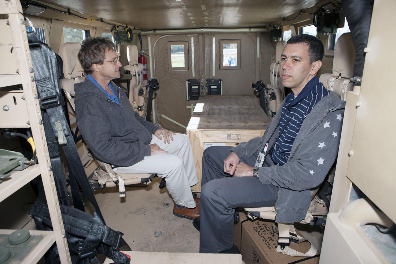 CAPE CANAVERAL, Fla. – Tom Hoffmann, left, and Danny Zeno, both Ground Systems Development and Operations, or GSDO, integration engineers, sit inside one of four new emergency egress vehicles, called Mine-Resistant Ambush-Protected, or MRAP, vehicles at the Maintenance and Operations Facility at NASA’s Kennedy Space Center in Florida. The MRAPs arrived from the U.S. Army Red River Depot in Texarkana, Texas in December 2013. The vehicles were processed in and then transported to the Rotation, Processing and Surge Facility near the Vehicle Assembly Building for temporary storage.  The GSDO Program at Kennedy led the efforts to an emergency egress vehicle that future astronauts could quickly use to leave the Launch Complex 39 area in case of an emergency. During crewed launches of NASA’s Space Launch System and Orion spacecraft, the MRAP will be stationed by the slidewire termination area at the pad. In case of an emergency, the crew will ride a slidewire to the ground and immediately board the MRAP for safe egress from the pad. The new vehicles replace the M-113 vehicles that were used during the Space Shuttle Program. Photo credit: NASA_Kim Shiflett