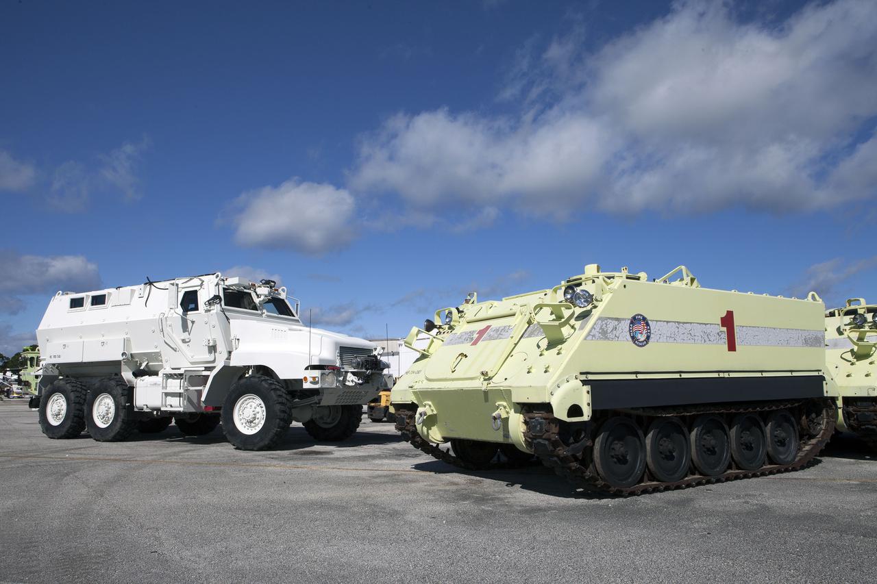 CAPE CANAVERAL, Fla. – One of four new emergency egress vehicles, called Mine-Resistant Ambush-Protection, or MRAP, vehicles sits near space shuttle-era M-113 vehicles at the Maintenance and Operations Facility at NASA’s Kennedy Space Center in Florida. The MRAPs arrived from the U.S. Army Red River Depot in Texarkana, Texas in December 2013. The vehicles were processed in and then transported to the Rotation, Processing and Surge Facility near the Vehicle Assembly Building for temporary storage.  The Ground Systems Development and Operations Program at Kennedy led the efforts to an emergency egress vehicle that future astronauts could quickly use to leave the Launch Complex 39 area in case of an emergency. During crewed launches of NASA’s Space Launch System and Orion spacecraft, the MRAP will be stationed by the slidewire termination area at the pad. In case of an emergency, the crew will ride a slidewire to the ground and immediately board the MRAP for safe egress from the pad. The new vehicles replace the M-113 vehicles that were used during the Space Shuttle Program. Photo credit: NASA_Kim Shiflett