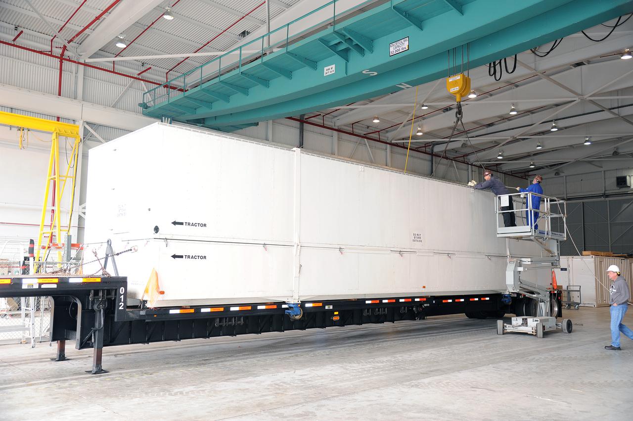 VANDENBERG AIR FORCE BASE, Calif. – A truck transporting the interstage adapter, or ISA, for NASA's Orbiting Carbon Observatory-2 mission, or OCO-2, backs into the high bay of the Building 836 hangar on Vandenberg Air Force Base in California.  OCO-2 is scheduled to launch aboard a United Launch Alliance Delta II rocket from Space Launch Complex 2 in July. The ISA is the interface between the Delta II first and second stages. The second stage engine fits within the ISA.  OCO-2 will collect precise global measurements of carbon dioxide in the Earth's atmosphere and provide scientists with a better idea of the chemical compound's impacts on climate change. Scientists will analyze this data to improve our understanding of the natural processes and human activities that regulate the abundance and distribution of this important atmospheric gas. To learn more about OCO-2, visit http:__oco.jpl.nasa.gov.  Photo credit: NASA_Jeremy Moore, 30th Space Wing, VAFB