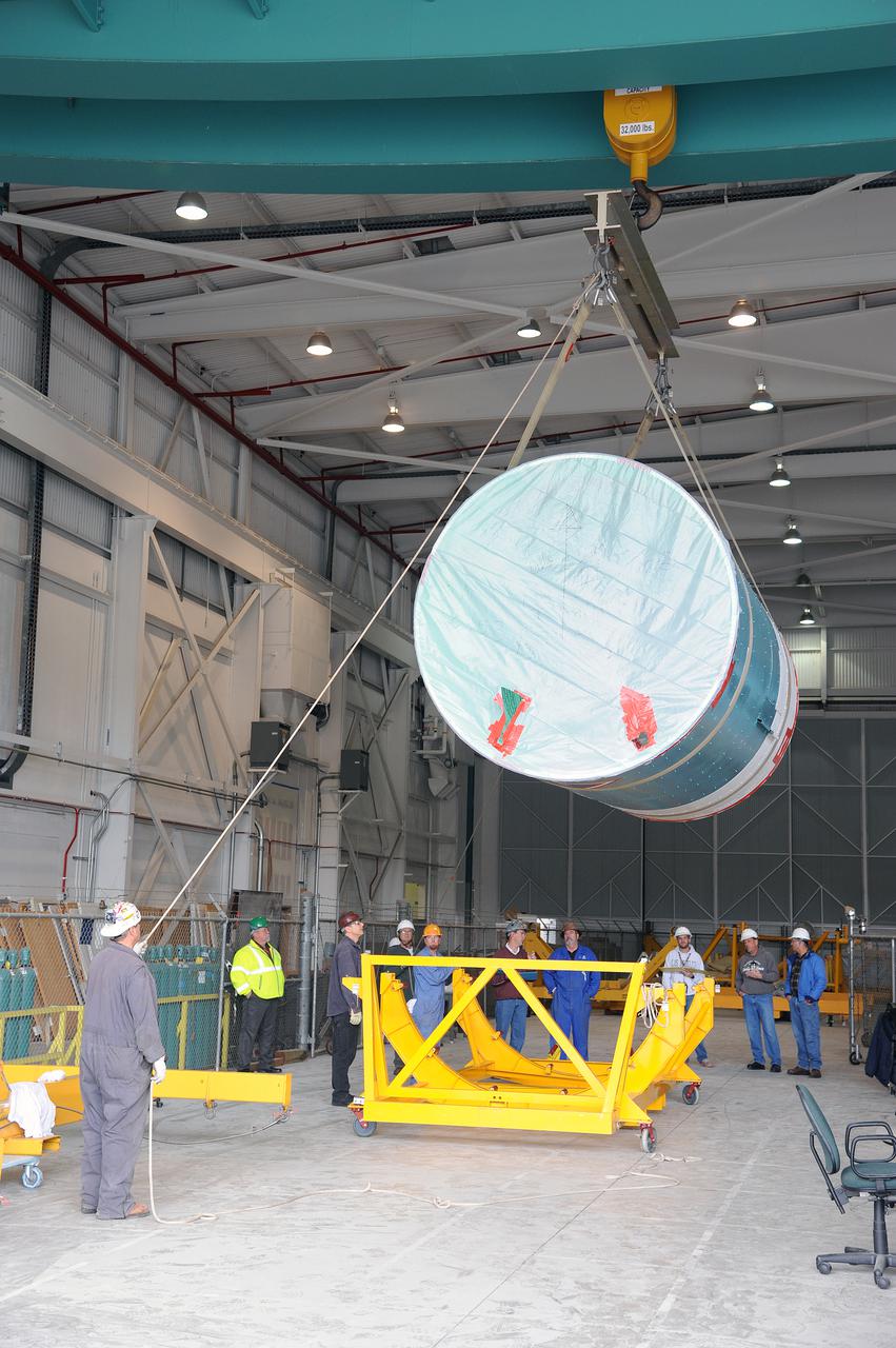 VANDENBERG AIR FORCE BASE, Calif. – Workers lower the interstage adapter, or ISA, for NASA's Orbiting Carbon Observatory-2 mission, or OCO-2, toward a transportation hardware cradle in the high bay of the Building 836 hangar on Vandenberg Air Force Base in California.  OCO-2 is scheduled to launch aboard a United Launch Alliance Delta II rocket from Space Launch Complex 2 in July. The ISA is the interface between the Delta II first and second stages. The second stage engine fits within the ISA.  OCO-2 will collect precise global measurements of carbon dioxide in the Earth's atmosphere and provide scientists with a better idea of the chemical compound's impacts on climate change. Scientists will analyze this data to improve our understanding of the natural processes and human activities that regulate the abundance and distribution of this important atmospheric gas. To learn more about OCO-2, visit http:__oco.jpl.nasa.gov.  Photo credit: NASA_Jeremy Moore, 30th Space Wing, VAFB