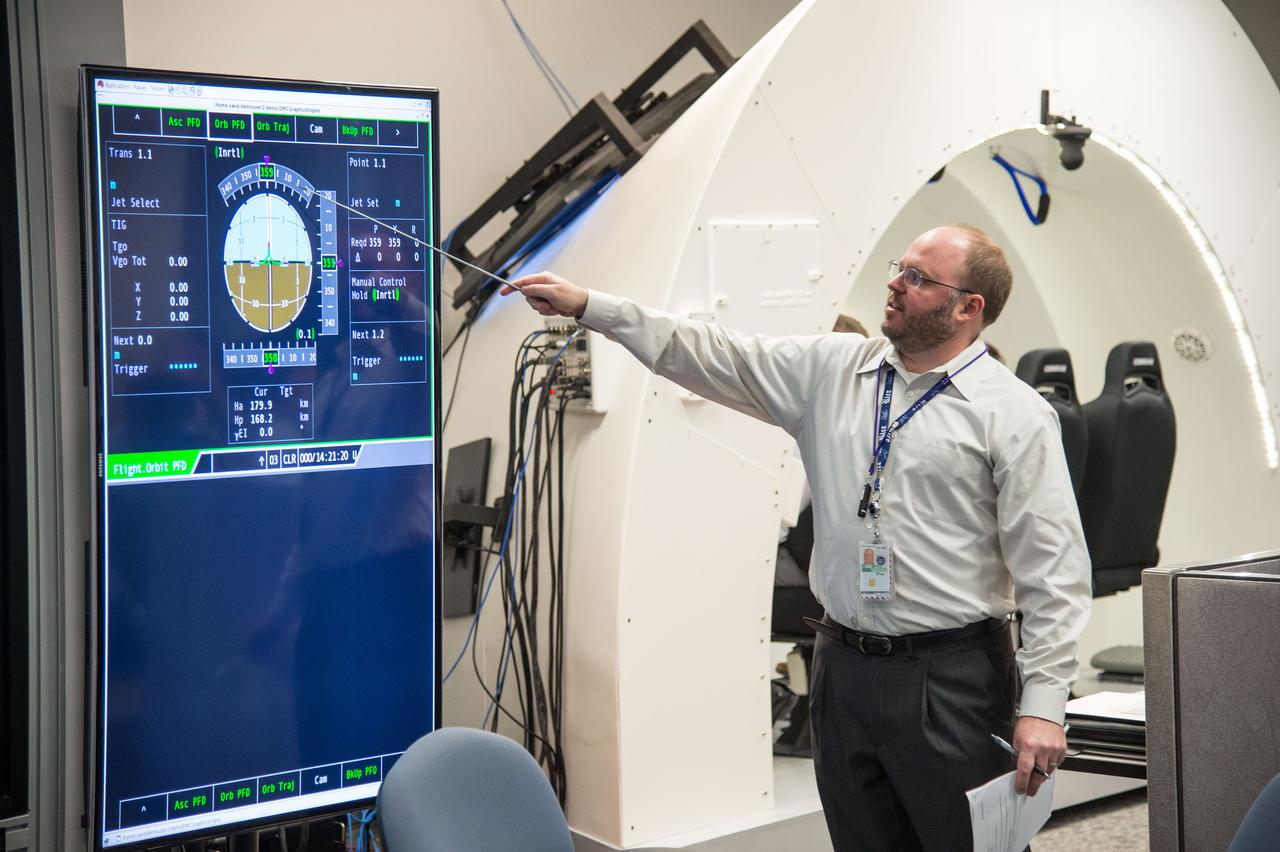 HOUSTON – An engineer with Boeing Space Exploration explains how to read the cockpit displays inside the company's CST-100 spacecraft simulator to NASA Commercial Crew Program engineers. Boeing demonstrated that the CST-100 software allows a human pilot to take over control of the spacecraft from the computer during all phases of a mission following separation from the launch vehicle. The pilot-in-the-loop demonstration at the Houston Product Support Center is a milestone under Boeing's Commercial Crew Integrated Capability agreement with the agency and its Commercial Crew Program. Photo credit: NASA_Bill Stafford