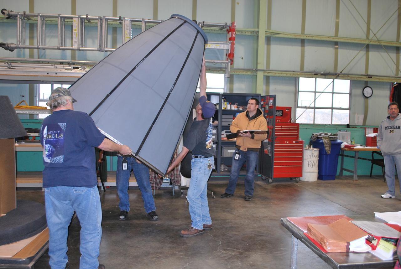 VANDENBERG AIR FORCE BASE, Calif. – In the Horizontal Processing Facility at Space Launch Complex 2 on Vandenberg Air Force Base in California, workers prepare to install the engine bell around the second-stage nozzle of the Delta II rocket for NASA's Orbiting Carbon Observatory-2 mission, or OCO-2. OCO-2 is scheduled to launch aboard a United Launch Alliance Delta II rocket from Space Launch Complex 2 in July. The rocket's second stage will insert OCO-2 into a polar Earth orbit. OCO-2 will collect precise global measurements of carbon dioxide in the Earth's atmosphere and provide scientists with a better idea of the chemical compound's impacts on climate change. Scientists will analyze this data to improve our understanding of the natural processes and human activities that regulate the abundance and distribution of this important atmospheric gas. To learn more about OCO-2, visit http:__oco.jpl.nasa.gov. Photo credit: NASA_Randy Beaudoin