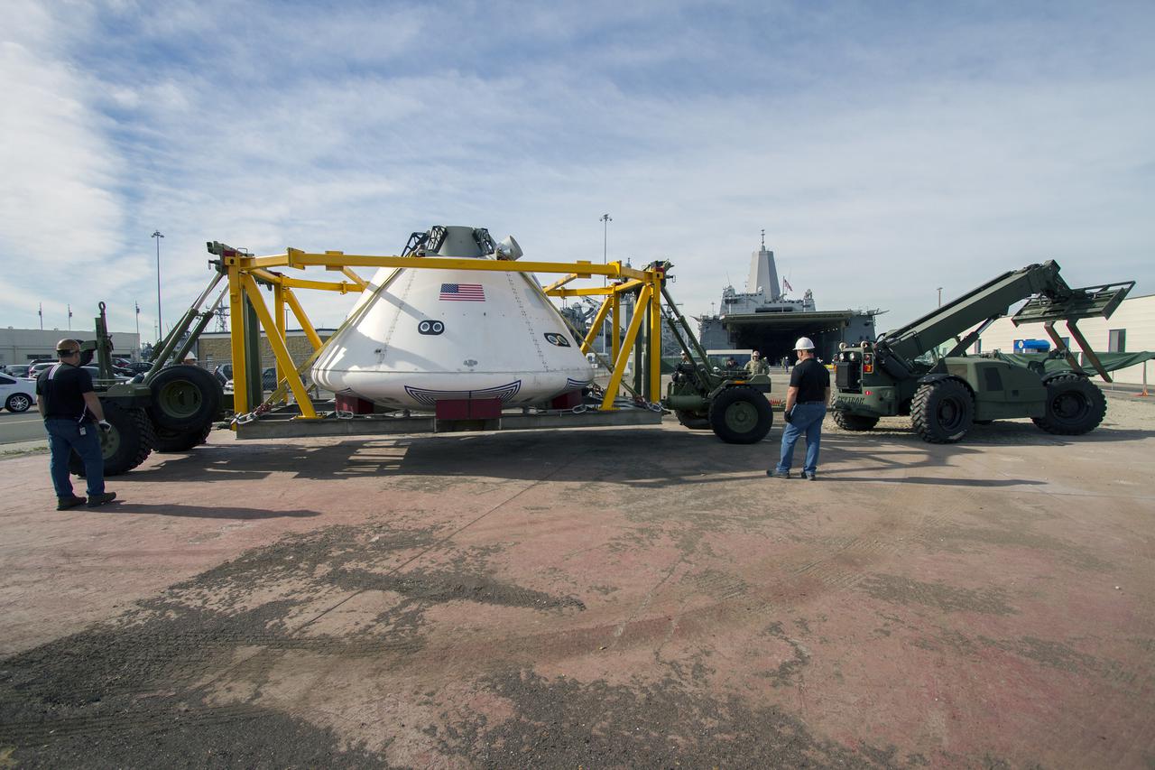SAN DIEGO, Calif. – The Orion boilerplate test vehicle arrived at the U.S. Naval Base San Diego in California, and was prepared for loading aboard the USS San Diego. Orion was transported in the ship’s well deck about 100 miles offshore for an underway recovery test. NASA and the U.S. Navy are conducting tests to prepare for recovery of the Orion crew module, forward bay cover and parachutes on its return from a deep space mission. The underway recovery test will allow the teams to demonstrate and evaluate the recovery processes, procedures, hardware and personnel in open waters. The Ground Systems Development and Operations Program Orion is the exploration spacecraft designed to carry astronauts to destinations not yet explored by humans, including an asteroid and Mars. It will have emergency abort capability, sustain the crew during space travel and provide safe re-entry from deep space return velocities. The first unpiloted test flight of the Orion is scheduled to launch in 2014 atop a Delta IV rocket and in 2017 on NASA’s Space Launch System rocket. For more information, visit http:__www.nasa.gov_orion. Photo credit: NASA_Cory Huston