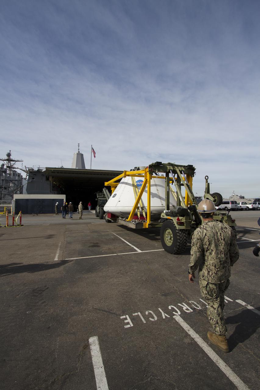 SAN DIEGO, Calif. – The Orion boilerplate test vehicle arrived at the U.S. Naval Base San Diego in California, and is being prepared to be loaded aboard the USS San Diego. Orion was transported in the ship’s well deck about 100 miles offshore for an underway recovery test. NASA and the U.S. Navy are conducting tests to prepare for recovery of the Orion crew module, forward bay cover and parachutes on its return from a deep space mission. The underway recovery test will allow the teams to demonstrate and evaluate the recovery processes, procedures, hardware and personnel in open waters. The Ground Systems Development and Operations Program Orion is the exploration spacecraft designed to carry astronauts to destinations not yet explored by humans, including an asteroid and Mars. It will have emergency abort capability, sustain the crew during space travel and provide safe re-entry from deep space return velocities. The first unpiloted test flight of the Orion is scheduled to launch in 2014 atop a Delta IV rocket and in 2017 on NASA’s Space Launch System rocket. For more information, visit http:__www.nasa.gov_orion. Photo credit: NASA_Cory Huston