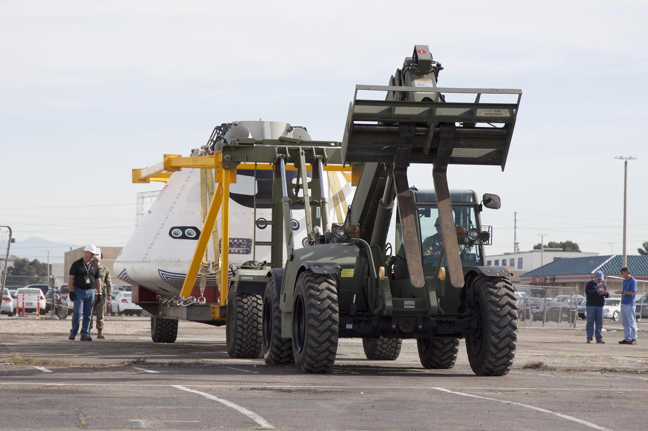 SAN DIEGO, Calif. – The Orion boilerplate test vehicle arrived at the U.S. Naval Base San Diego in California, and is being prepared to be loaded aboard the USS San Diego. Orion was transported in the ship’s well deck about 100 miles offshore for an underway recovery test. NASA and the U.S. Navy are conducting tests to prepare for recovery of the Orion crew module, forward bay cover and parachutes on its return from a deep space mission. The underway recovery test will allow the teams to demonstrate and evaluate the recovery processes, procedures, hardware and personnel in open waters. The Ground Systems Development and Operations Program Orion is the exploration spacecraft designed to carry astronauts to destinations not yet explored by humans, including an asteroid and Mars. It will have emergency abort capability, sustain the crew during space travel and provide safe re-entry from deep space return velocities. The first unpiloted test flight of the Orion is scheduled to launch in 2014 atop a Delta IV rocket and in 2017 on NASA’s Space Launch System rocket. For more information, visit http:__www.nasa.gov_orion. Photo credit: NASA_Cory Huston