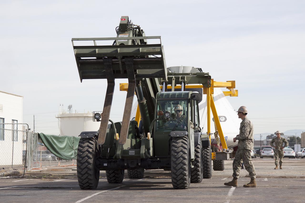 SAN DIEGO, Calif. – The Orion boilerplate test vehicle arrived at the U.S. Naval Base San Diego in California, and is being prepared to be loaded aboard the USS San Diego. Orion was transported in the ship’s well deck about 100 miles offshore for an underway recovery test. NASA and the U.S. Navy are conducting tests to prepare for recovery of the Orion crew module, forward bay cover and parachutes on its return from a deep space mission. The underway recovery test will allow the teams to demonstrate and evaluate the recovery processes, procedures, hardware and personnel in open waters. The Ground Systems Development and Operations Program Orion is the exploration spacecraft designed to carry astronauts to destinations not yet explored by humans, including an asteroid and Mars. It will have emergency abort capability, sustain the crew during space travel and provide safe re-entry from deep space return velocities. The first unpiloted test flight of the Orion is scheduled to launch in 2014 atop a Delta IV rocket and in 2017 on NASA’s Space Launch System rocket. For more information, visit http:__www.nasa.gov_orion. Photo credit: NASA_Cory Huston