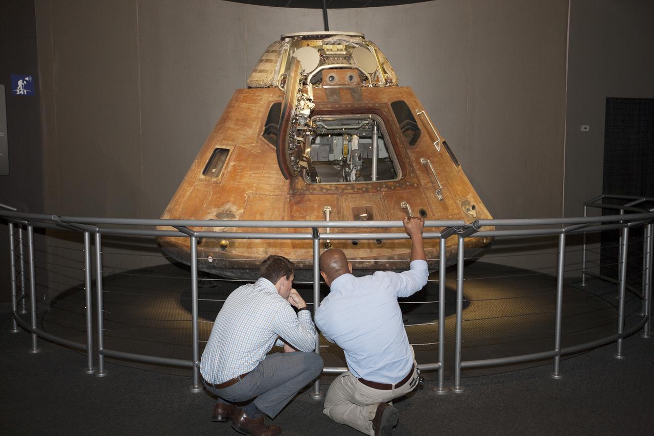 CAPE CANAVERAL, Fla. – NASA astronaut candidates Josh Cassada, left, and Victor Glover observe the Apollo 14 command module which carried astronauts Alan Shepard, Stu Roosa and Edgar Mitchell on their lunar landing mission in 1971.The astronauts toured the Apollo Saturn V Center at Kennedy Space Center in Florida during a daylong set of briefings and tours of different facilities at NASA's primary launch center. The astronaut class of 2013 was selected by NASA after an extensive year-and-a-half search. The new group will help the agency push the boundaries of exploration and travel to new destinations in the solar system. To learn more about the astronaut class of 2013, visit: http:__www.nasa.gov_astronauts_2013astroclass.html Photo credit: NASA_Kim Shiflett