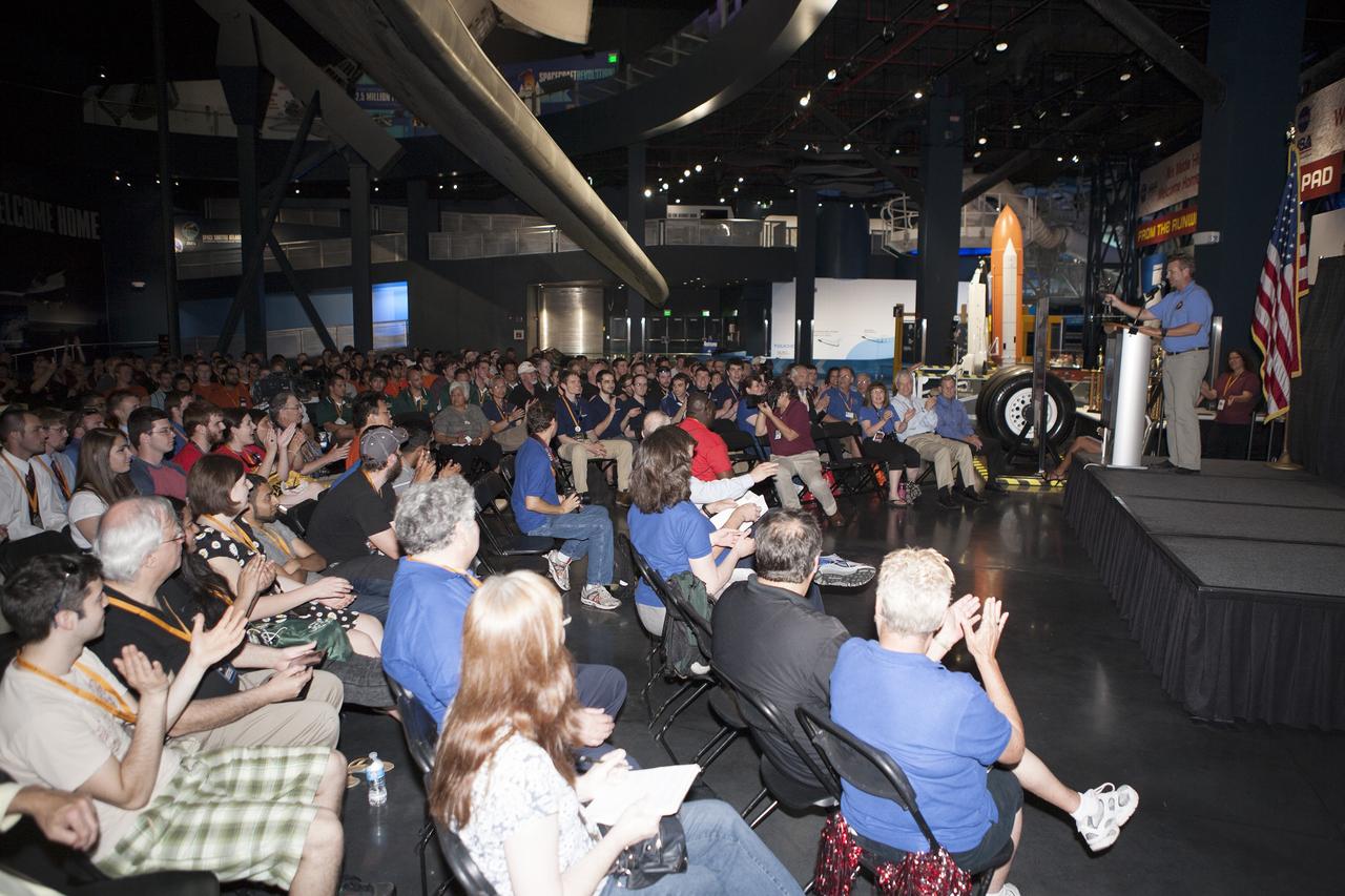 CAPE CANAVERAL, Fla. -- Rob Mueller announces the winner of the Judges' Innovation Award during NASA's 2014 Robotic Mining Competition awards ceremony inside the Space Shuttle Atlantis attraction at the Kennedy Space Center Visitor Complex in Florida. More than 35 teams from colleges and universities around the U.S. designed and built remote-controlled robots for the mining competition. The competition is a NASA Human Exploration and Operations Mission Directorate project designed to engage and retain students in science, technology, engineering and mathematics, or STEM, fields by expanding opportunities for student research and design. Teams use their remote-controlled robotics to maneuver and dig in a supersized sandbox filled with a crushed material that has characteristics similar to Martian soil. The objective of the challenge is to see which team’s robot can collect and move the most regolith within a specified amount of time. The competition includes on-site mining, writing a systems engineering paper, performing outreach projects for K-12 students, slide presentation and demonstrations, and team spirit. For more information, visit www.nasa.gov/nasarmc. Photo credit: NASA/Kim Shiflett