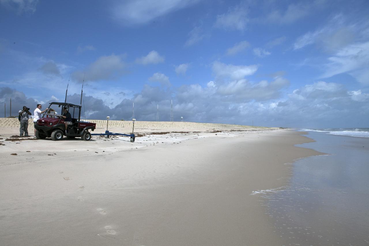 CAPE CANAVERAL, Fla. -- At the Kennedy Space Center in Florida, University of Florida geologists and NASA biologists use an all-terrain vehicle to survey sand dunes that have been restored along a 1.2 mile stretch of shoreline near Launch Pads 39A and B. As part of a six-month effort to help prevent further erosion, 180,000 shrubs, including grasses, sunflowers, vines, sea grapes and palmettos were planted.      Constant pounding from tropical storms, such as Hurricane Sandy in October of 2012, other weather systems and higher than usual tides, destroyed sand dunes protecting infrastructure at the spaceport. Photo credit: NASA/Dan Casper