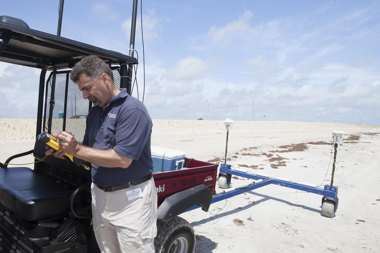 CAPE CANAVERAL, Fla. -- At the Kennedy Space Center in Florida, University of Florida geologists and NASA biologists use an all-terrain vehicle to survey sand dunes that have been restored along a 1.2 mile stretch of shoreline near Launch Pads 39A and B. As part of a six-month effort to help prevent further erosion, 180,000 shrubs, including grasses, sunflowers, vines, sea grapes and palmettos were planted.      Constant pounding from tropical storms, such as Hurricane Sandy in October of 2012, other weather systems and higher than usual tides, destroyed sand dunes protecting infrastructure at the spaceport. Photo credit: NASA/Dan Casper