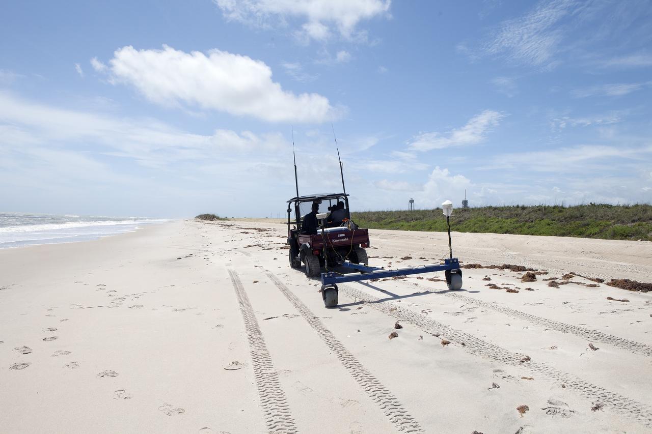 CAPE CANAVERAL, Fla. -- Rich MacKenzie, who earned a doctorate in geological sciences at the University of Florida, collects Global Positioning System survey measurements along a restored 1.2 mile stretch of shoreline near Launch Pads 39A and B. Experts from University of Florida are working with NASA scientists to better understand beach erosion.      Constant pounding from tropical storms, such as Hurricane Sandy in October of 2012, other weather systems and higher than usual tides, destroyed sand dunes protecting infrastructure at the spaceport. Photo credit: NASA/Dan Casper