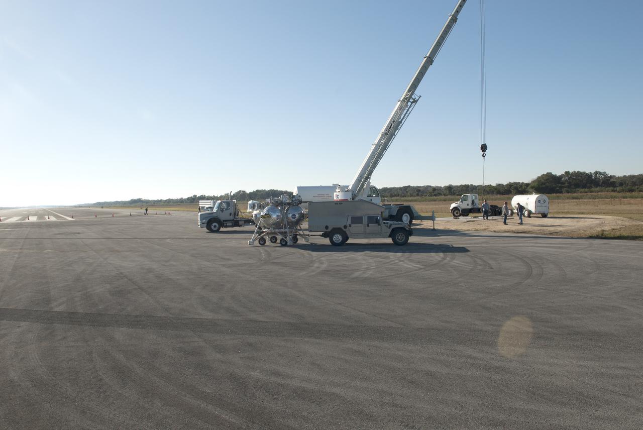 CAPE CANAVERAL, Fla. – NASA’s Project Morpheus prototype lander is moved into position at the north end of the Shuttle Landing Facility at Kennedy Space Center in Florida in preparation for free flight test No. 15. During the 97-second test, onboard autonomous landing and hazard avoidance technology sensors, or ALHAT, surveyed the hazard field for safe landing sites, then guided the lander forward and downward to a successful landing. For more information on Morpheus, visit: http:__www.morpheuslander.jsc.nasa.gov. Photo credit: NASA_Jim Grossman