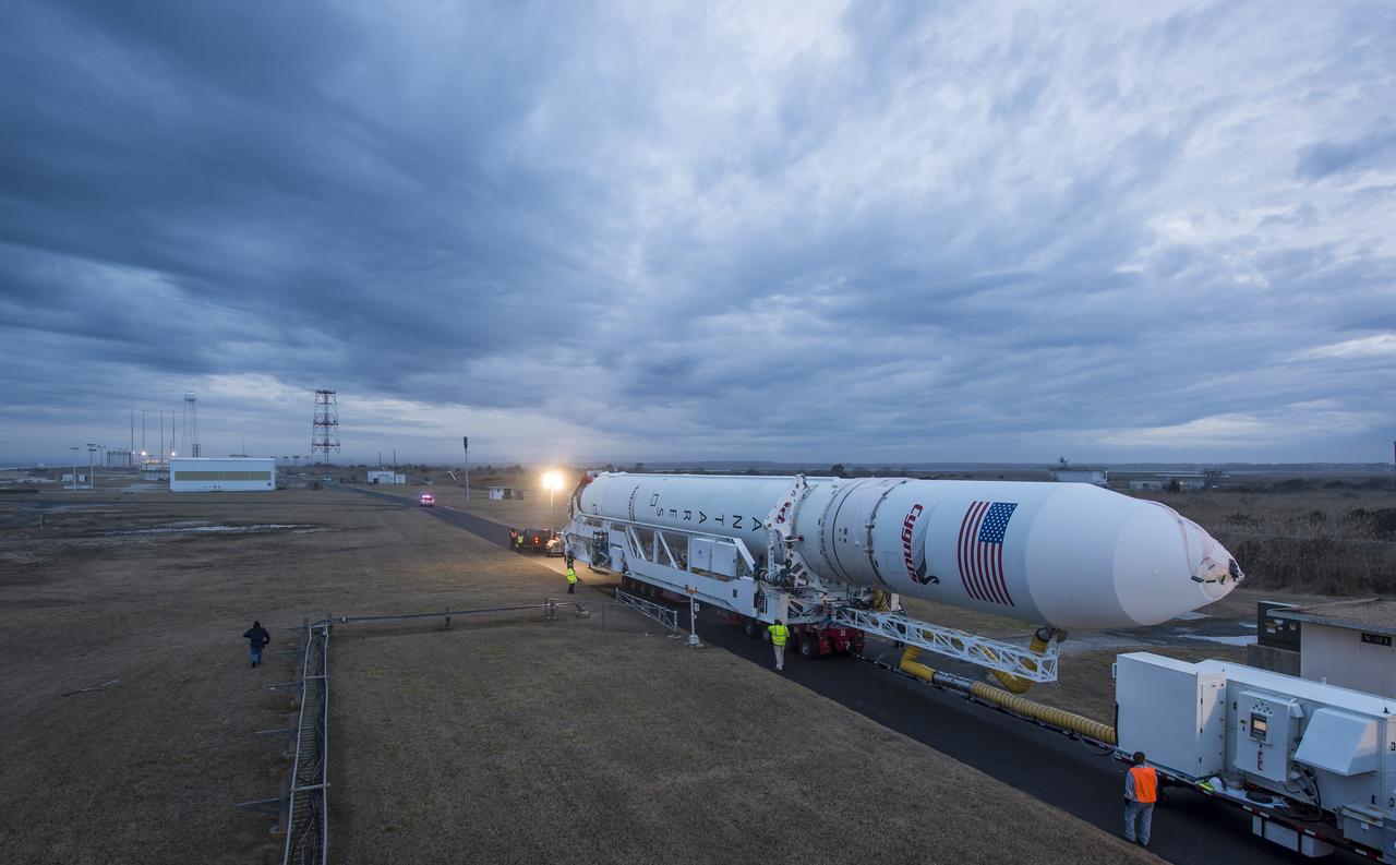 An Orbital Sciences Corporation Antares rocket is seen as it is rolled out to launch Pad-0A at NASA's Wallops Flight Facility, Sunday, January 5, 2014 in advance of a planned Wednesday, Jan. 8th, 1:32 p.m. EST launch, Wallops Island, VA. The Antares will launch a Cygnus spacecraft on a cargo resupply mission to the International Space Station. The Orbital-1 mission is Orbital Sciences' first contracted cargo delivery flight to the space station for NASA. Among the cargo aboard Cygnus set to launch to the space station are science experiments, crew provisions, spare parts and other hardware. Photo Credit: (NASA/Bill Ingalls)