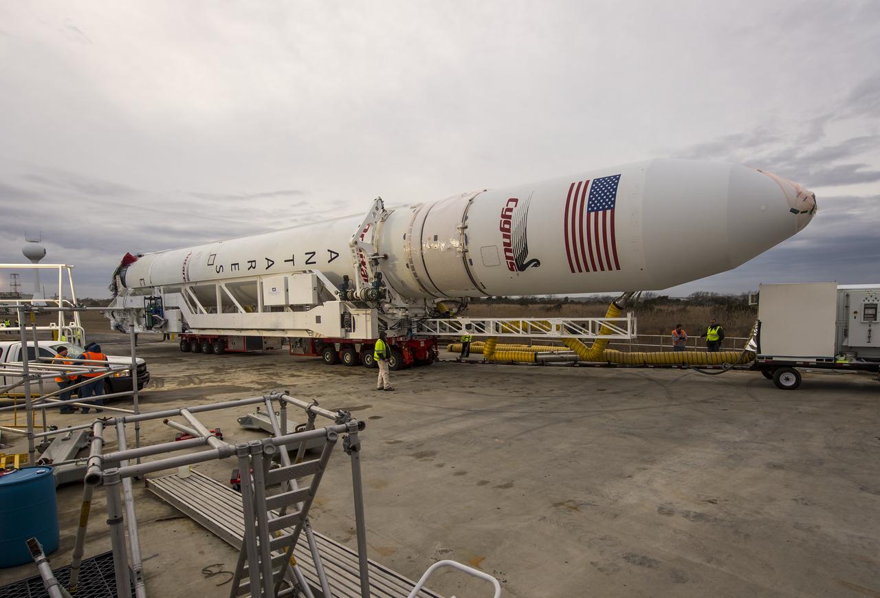 An Orbital Sciences Corporation Antares rocket is seen as it is rolled out to launch Pad-0A at NASA's Wallops Flight Facility, Sunday, January 5, 2014 in advance of a planned Wednesday, Jan. 8th, 1:32 p.m. EST launch, Wallops Island, VA. The Antares will launch a Cygnus spacecraft on a cargo resupply mission to the International Space Station. The Orbital-1 mission is Orbital Sciences' first contracted cargo delivery flight to the space station for NASA. Among the cargo aboard Cygnus set to launch to the space station are science experiments, crew provisions, spare parts and other hardware. Photo Credit: (NASA/Bill Ingalls)