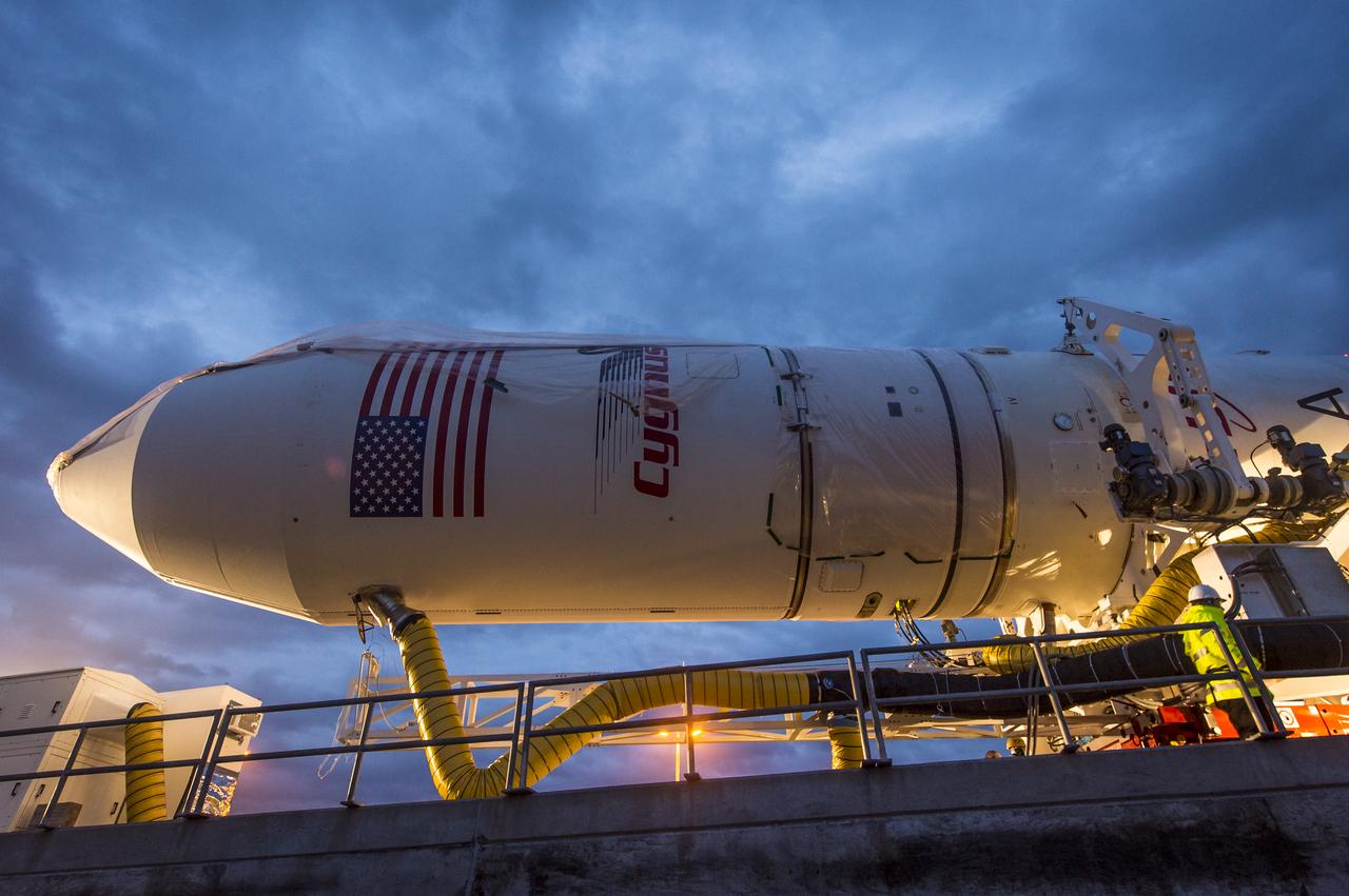 An Orbital Sciences Corporation Antares rocket is seen as it is rolled out to launch Pad-0A at NASA's Wallops Flight Facility, Sunday, January 5, 2014 in advance of a planned Wednesday, Jan. 8th, 1:32 p.m. EST launch, Wallops Island, VA. The Antares will launch a Cygnus spacecraft on a cargo resupply mission to the International Space Station. The Orbital-1 mission is Orbital Sciences' first contracted cargo delivery flight to the space station for NASA. Among the cargo aboard Cygnus set to launch to the space station are science experiments, crew provisions, spare parts and other hardware. Photo Credit: (NASA/Bill Ingalls)