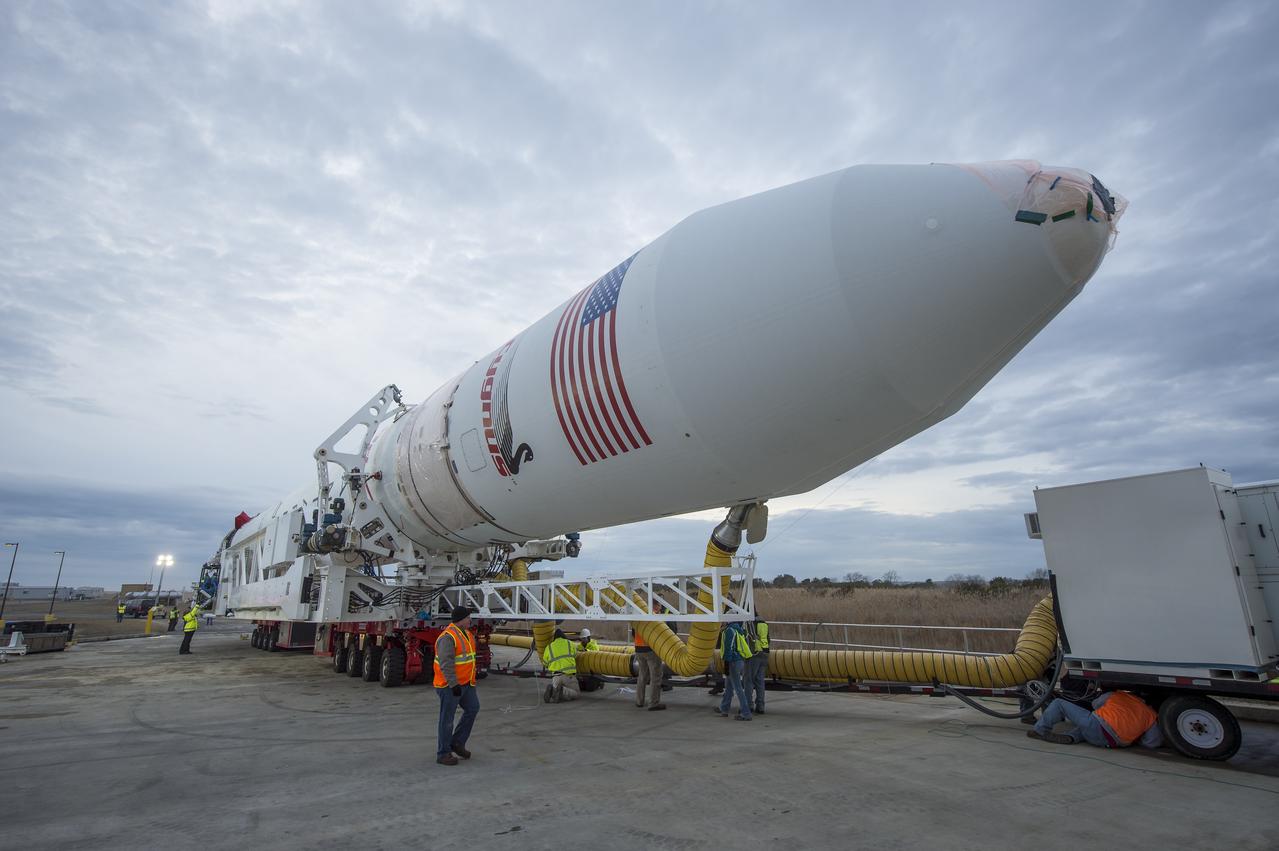 An Orbital Sciences Corporation Antares rocket is seen as it is rolled out to launch Pad-0A at NASA's Wallops Flight Facility, Sunday, January 5, 2014 in advance of a planned Wednesday, Jan. 8th, 1:32 p.m. EST launch, Wallops Island, VA. The Antares will launch a Cygnus spacecraft on a cargo resupply mission to the International Space Station. The Orbital-1 mission is Orbital Sciences' first contracted cargo delivery flight to the space station for NASA. Among the cargo aboard Cygnus set to launch to the space station are science experiments, crew provisions, spare parts and other hardware. Photo Credit: (NASA/Bill Ingalls)