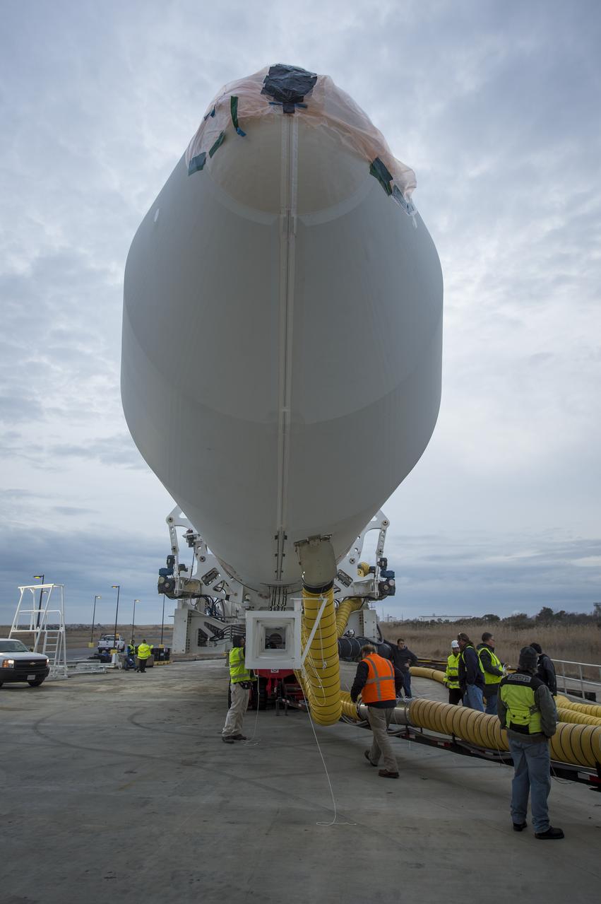 An Orbital Sciences Corporation Antares rocket is seen as it is rolled out to launch Pad-0A at NASA's Wallops Flight Facility, Sunday, January 5, 2014 in advance of a planned Wednesday, Jan. 8th, 1:32 p.m. EST launch, Wallops Island, VA. The Antares will launch a Cygnus spacecraft on a cargo resupply mission to the International Space Station. The Orbital-1 mission is Orbital Sciences' first contracted cargo delivery flight to the space station for NASA. Among the cargo aboard Cygnus set to launch to the space station are science experiments, crew provisions, spare parts and other hardware. Photo Credit: (NASA/Bill Ingalls)
