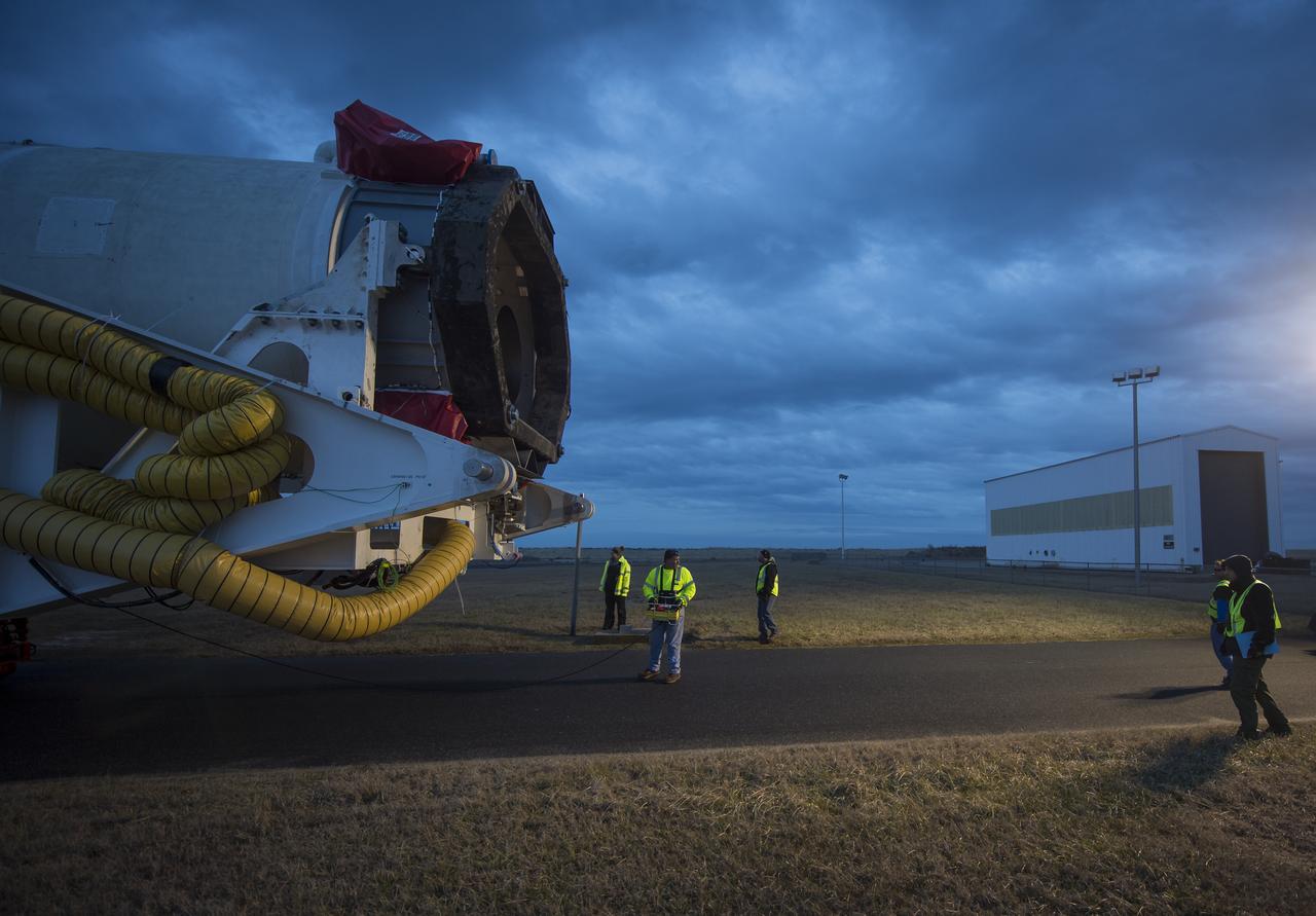 An Orbital Sciences Corporation Antares rocket is seen as it is rolled out to launch Pad-0A at NASA's Wallops Flight Facility, Sunday, January 5, 2014 in advance of a planned Wednesday, Jan. 8th, 1:32 p.m. EST launch, Wallops Island, VA. The Antares will launch a Cygnus spacecraft on a cargo resupply mission to the International Space Station. The Orbital-1 mission is Orbital Sciences' first contracted cargo delivery flight to the space station for NASA. Among the cargo aboard Cygnus set to launch to the space station are science experiments, crew provisions, spare parts and other hardware. Photo Credit: (NASA/Bill Ingalls)
