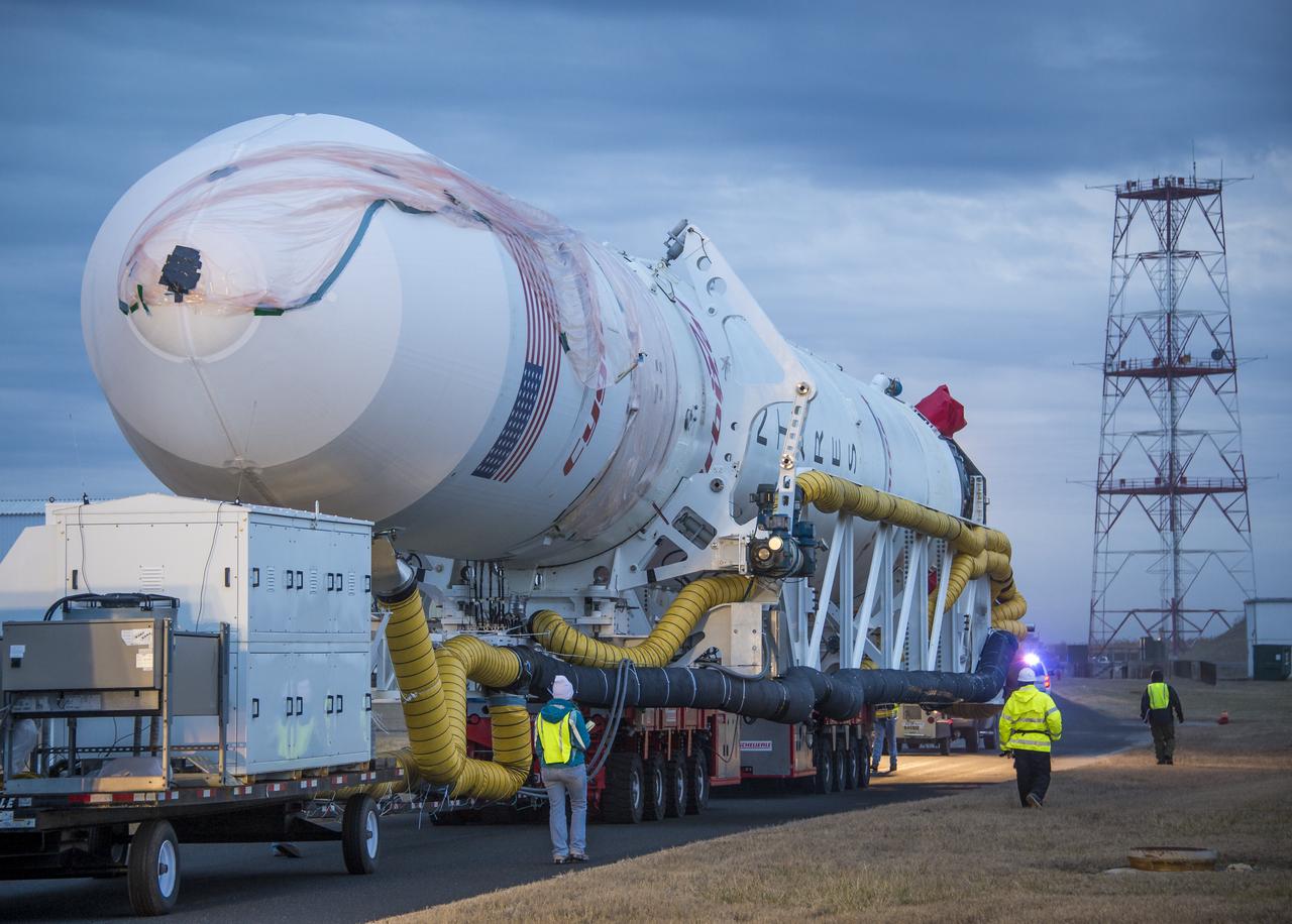 An Orbital Sciences Corporation Antares rocket is seen as it is rolled out to launch Pad-0A at NASA's Wallops Flight Facility, Sunday, January 5, 2014 in advance of a planned Wednesday, Jan. 8th, 1:32 p.m. EST launch, Wallops Island, VA. The Antares will launch a Cygnus spacecraft on a cargo resupply mission to the International Space Station. The Orbital-1 mission is Orbital Sciences' first contracted cargo delivery flight to the space station for NASA. Among the cargo aboard Cygnus set to launch to the space station are science experiments, crew provisions, spare parts and other hardware. Photo Credit: (NASA/Bill Ingalls)