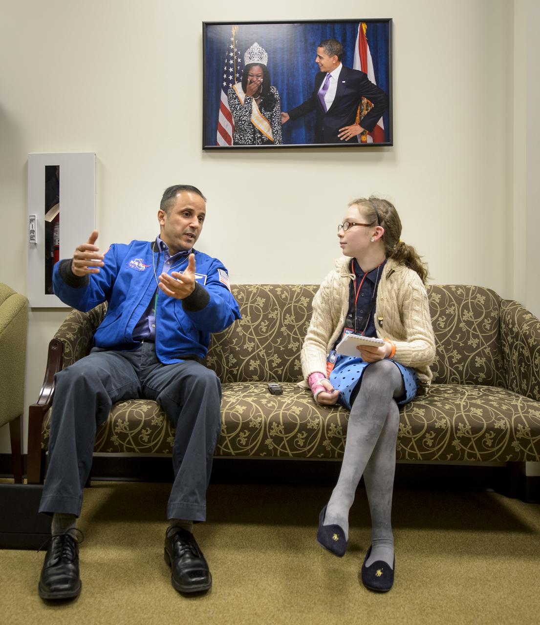NASA Astronaut Joe Acaba, left, is interviewed by TIME for Kids reporter Grace Clark ahead of the annual White House State of Science, Technology, Engineering, and Math (SoSTEM) address, Wednesday, Jan. 29, 2014,  in the South Court Auditorium in the Eisenhower Executive Office Building on the White House complex in Washington. Photo Credit: (NASA/Bill Ingalls)