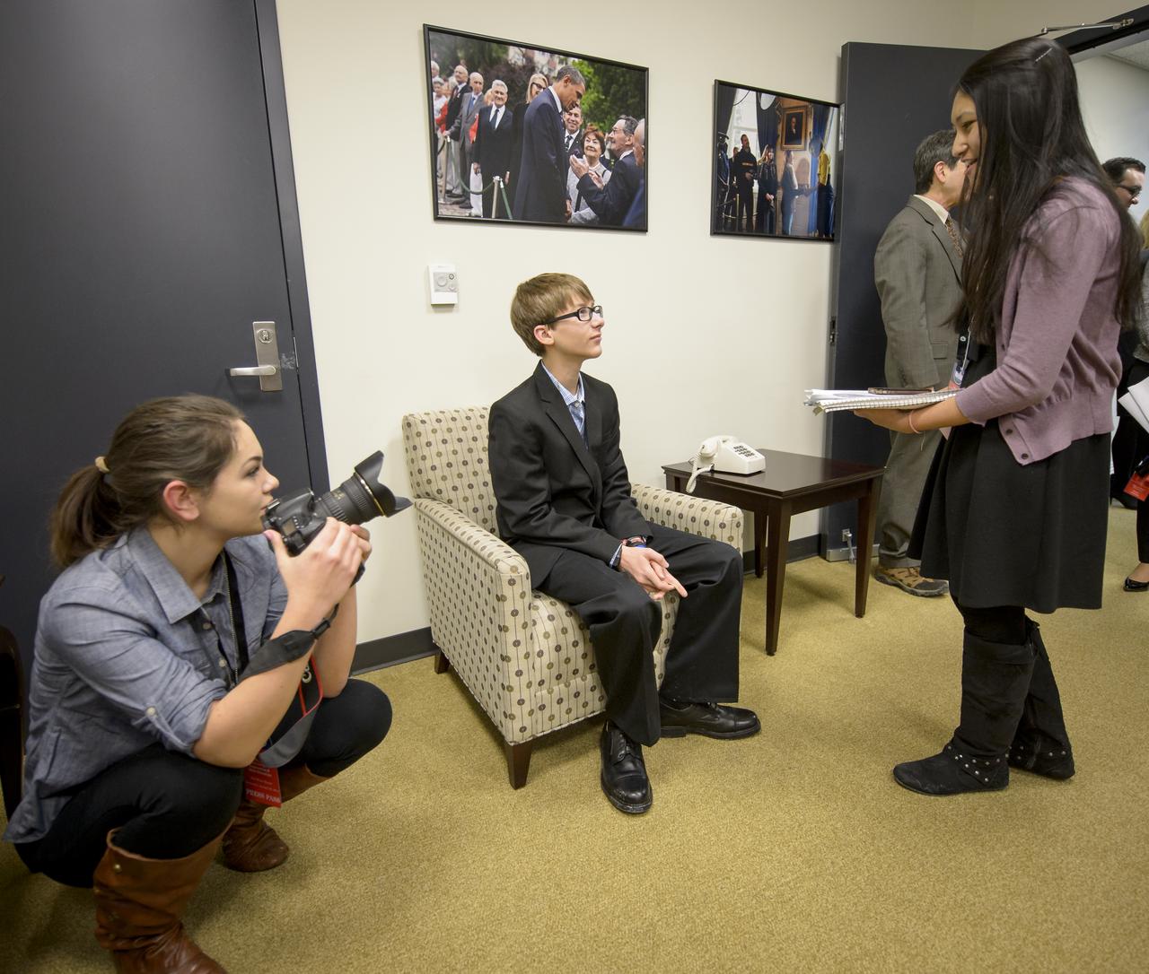 Montgomery Blair High School Student Newspaper “Silver Chips” Online Editor-in-Chief Aanchal Johri, right, and Photo Editor Emma Howells, left, from Silver Spring, MD. interview Joey Hudy, Anthem, AZ, 16-year-old self-described “Maker” at the annual White House State of Science, Technology, Engineering, and Math (SoSTEM) address, Wednesday, Jan. 29, 2014,  in the South Court Auditorium in the Eisenhower Executive Office Building on the White House complex in Washington. Joey sat with the First Lady at the President’s 2014 State of the Union Address after his first shot to fame in 2012 when he attended the White House Science Fair where the President took a turn using his “extreme marshmallow cannon” to launch a marshmallow across the East Room of the White House.  Photo Credit: (NASA/Bill Ingalls)