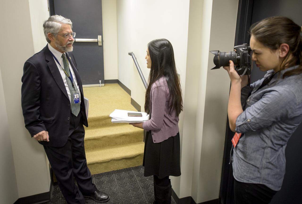 Dr. John P. Holdren, Assistant to the President for Science and Technology and Director of the White House Office of Science & Technology Policy, left, is interviewed by Montgomery Blair High School Student Newspaper “Silver Chips” Online Editor-in-Chief Aanchal Johri, center, and Photo Editor Emma Howells, from Silver Spring, MD. ahead of the annual White House State of Science, Technology, Engineering, and Math (SoSTEM) address, Wednesday, Jan. 29, 2014, in the South Court Auditorium in the Eisenhower Executive Office Building on the White House complex in Washington. Photo Credit: (NASA/Bill Ingalls)