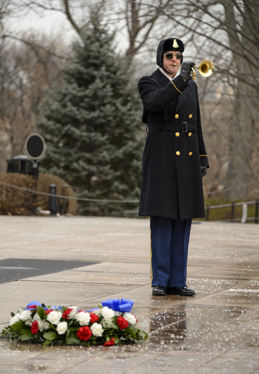 Taps is played by the Honor Guard after NASA Administrator Charles Bolden and his wife Alexis laid a wreath at the Tomb of the Unknowns as part of NASA's Day of Remembrance, Friday, Jan. 31, 2014, at Arlington National Cemetery.  The wreaths were laid in memory of those men and women who lost their lives in the quest for space exploration.  Photo Credit: (NASA/Bill Ingalls)