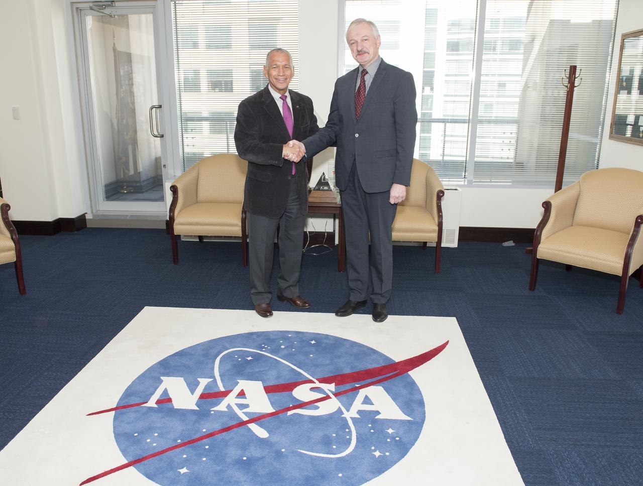 NASA Administrator Charles Bolden, left, welcomes Lithuania's Minister of Economy Evaldas Gustas to NASA Headquarters to discuss potential collaborative space activities between NASA and the Republic of Lithuania, Tuesday, Feb. 18, 2014 in Washington.