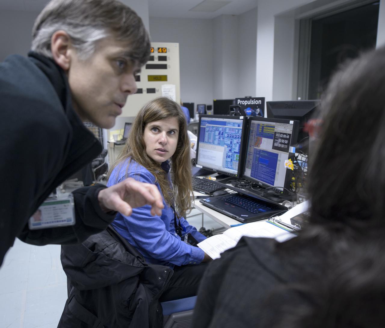 Andy Aylward, NASA GPM EGSE, left, Beth Weinsteen, NASA GPM Integration and Testing Team, center, and another GPM team member, talk during the all-day launch simulation for the Global Precipitation Measurement (GPM) Core Observatory at the Spacecraft Test and Assembly Building 2 (STA2), Saturday, Feb. 22, 2014, Tanegashima Space Center (TNSC), Tanegashima Island, Japan. Japan Aerospace Exploration Agency (JAXA) plans to launch an H-IIA rocket carrying the GPM Core Observatory on Feb. 28, 2014. The NASA-JAXA GPM spacecraft will collect information that unifies data from an international network of existing and future satellites to map global rainfall and snowfall every three hours. Photo Credit: (NASA/Bill Ingalls)