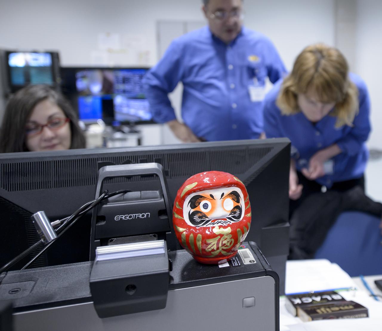 A daruma doll is seen amongst the NASA GPM Mission launch team in the Spacecraft Test and Assembly Building 2 (STA2) during the all-day launch simulation for the Global Precipitation Measurement (GPM) Core Observatory, Saturday, Feb. 22, 2014, Tanegashima Space Center (TNSC), Tanegashima Island, Japan. One eye of the daruma doll is colored in when a goal is set, in this case a successful launch of GPM, and the second eye is colored in at the completion of the goal. Japan Aerospace Exploration Agency (JAXA) plans to launch an H-IIA rocket carrying the GPM Core Observatory on Feb. 28, 2014. The NASA-JAXA GPM spacecraft will collect information that unifies data from an international network of existing and future satellites to map global rainfall and snowfall every three hours. Photo Credit: (NASA/Bill Ingalls)