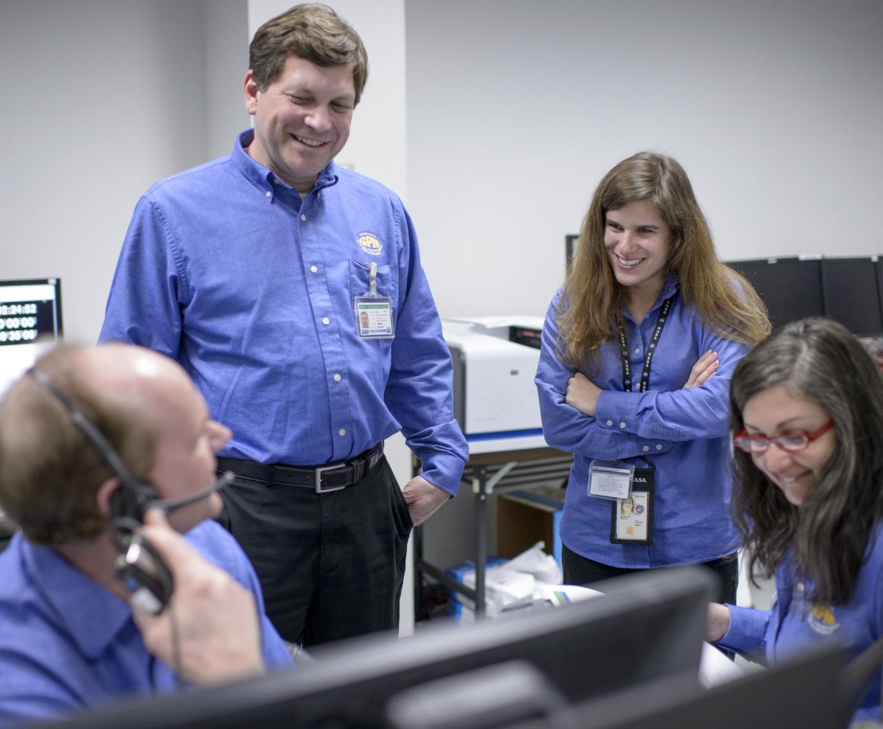 NASA GPM Systems team members, Tim Grunner, left, Harry Culver, 2nd from left, and, Liza Bartusek, right, talk, along with with GPM Testing team member Beth Weinsteen, during an all-day launch simulation for the Global Precipitation Measurement (GPM) Core Observatory at the Spacecraft Test and Assembly Building 2 (STA2), Saturday, Feb. 22, 2014, Tanegashima Space Center (TNSC), Tanegashima Island, Japan. Japan Aerospace Exploration Agency (JAXA) plans to launch an H-IIA rocket carrying the GPM Core Observatory on Feb. 28, 2014. The NASA-JAXA GPM spacecraft will collect information that unifies data from an international network of existing and future satellites to map global rainfall and snowfall every three hours. Photo Credit: (NASA/Bill Ingalls)
